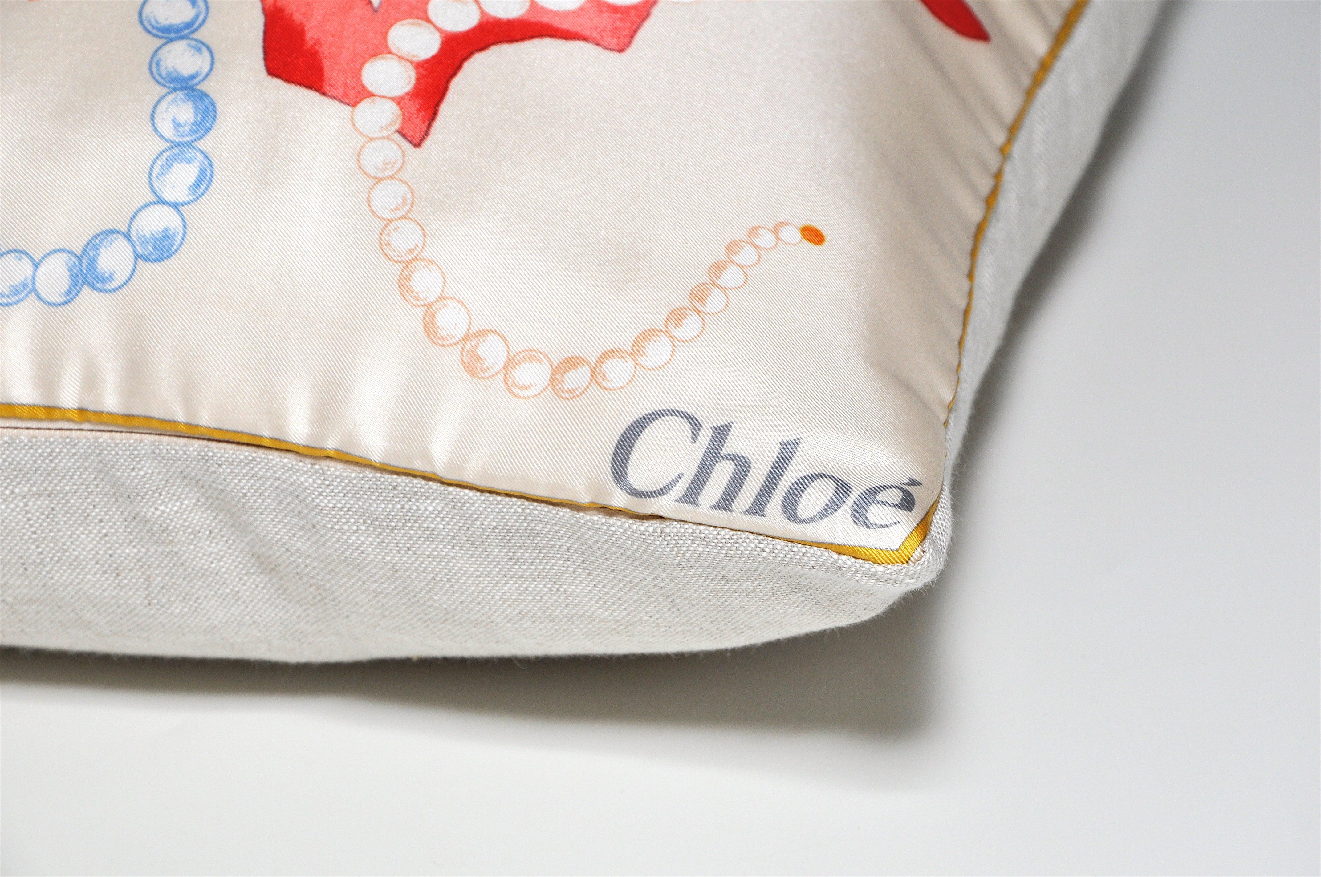Title:
Vintage Chloe Nautical Pearl Coral Silk Scarf with Irish Linen Cushion Pillow 

Description:
Custom made one-of-a-kind luxury cushion (pillow) created from an exquisite vintage silk Chloe fashion scarf in a beautiful, magical, underwater