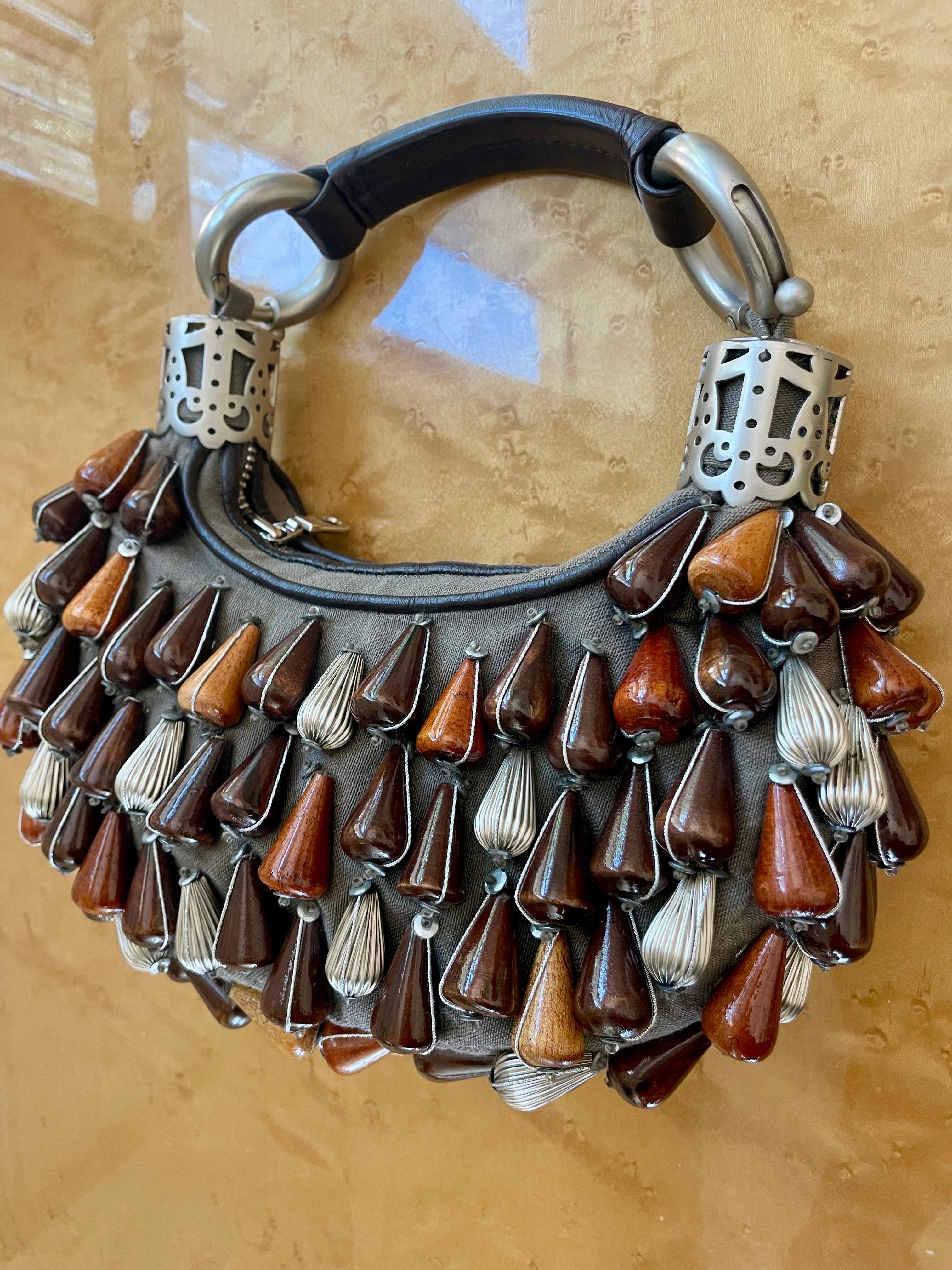 Chloé’s 2002 collection, created under Phoebe Philo's vision, featured muddled neutral colors elevated by elaborate, chunky, Moroccan-style beaded handbags. Chloé garments and accessories are all about detail and aesthetic quirk. Utilizing organic