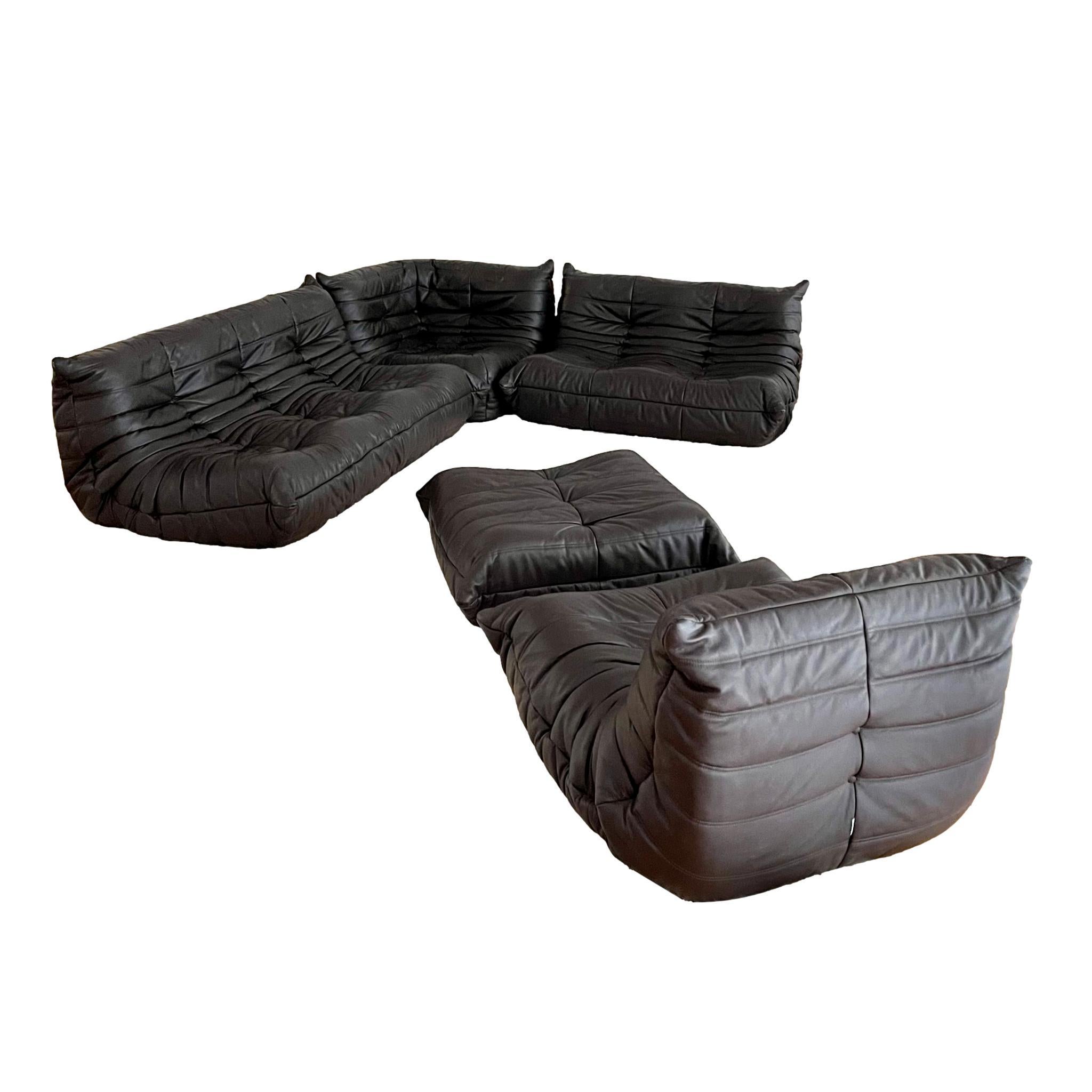 Classic French Togo set by Michel Ducaroy for luxury brand Ligne Roset. Originally designed in the 1970s the iconic togo sofa is now a design classic. This set comes in it's original chocolate brown leather. 

Timeless comfort and style make this