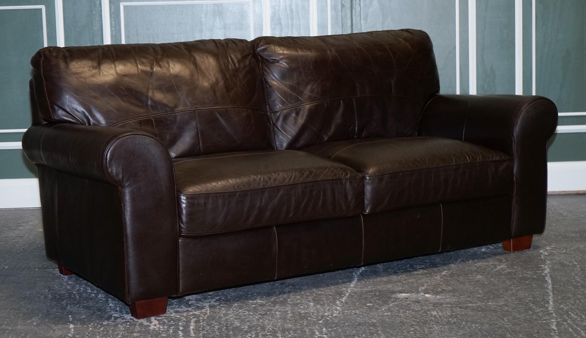 
We are delighted to Present This Vintage Chocolate Brown Leather Two To Three Seater Sofa.

Very good-looking sofa with all the cushions sewn into the sofa. 

We have deep cleaned the sofa throughout, hand waxed and hand polished the