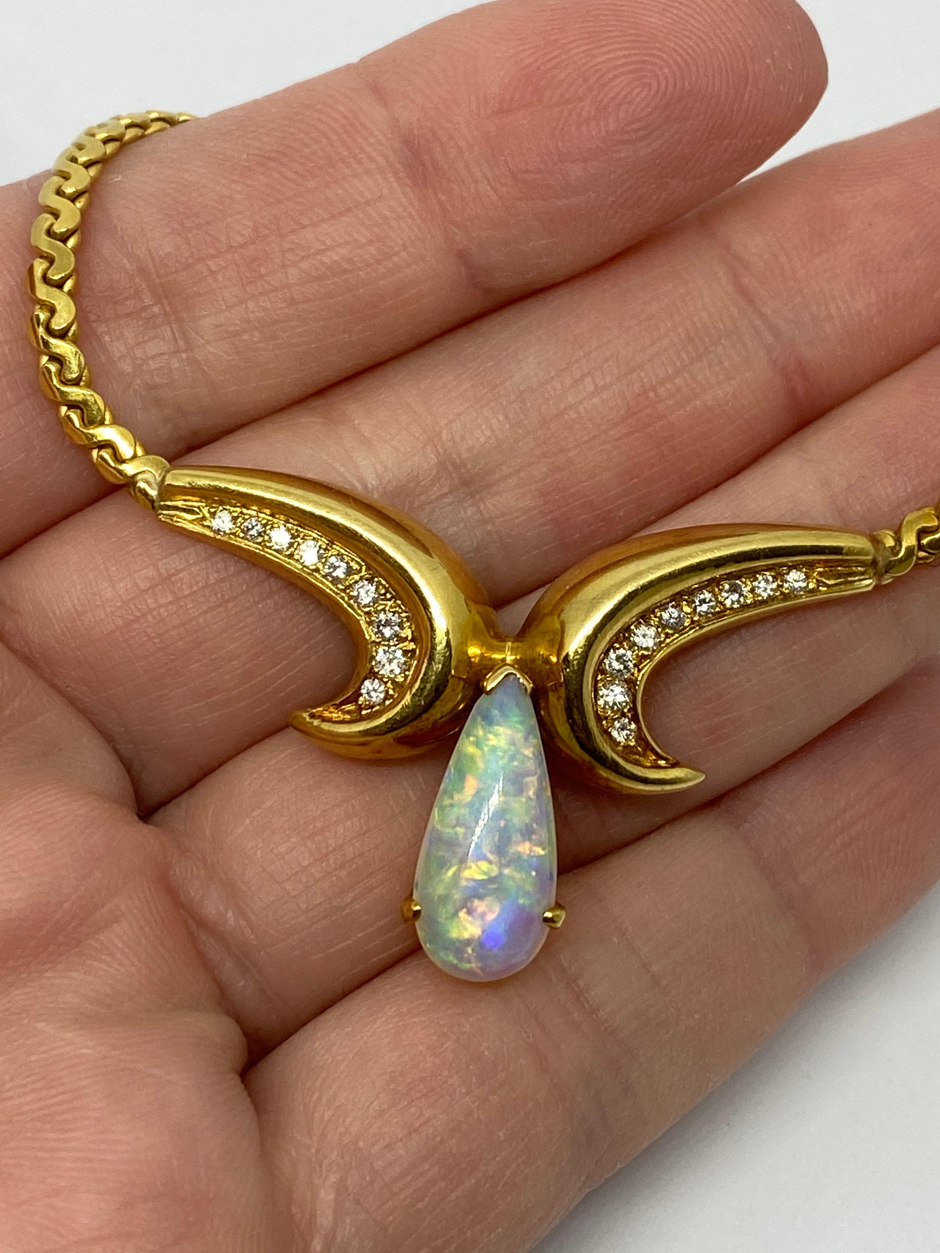 This is a preowned necklace in mint condition. The large pear-shaped opal measures 16 x 7mm and is approximately 2.50cts. The opal is clear in transparency with no matrix behind it and has lots of flashes of blue, green, yellow, red, and orange play