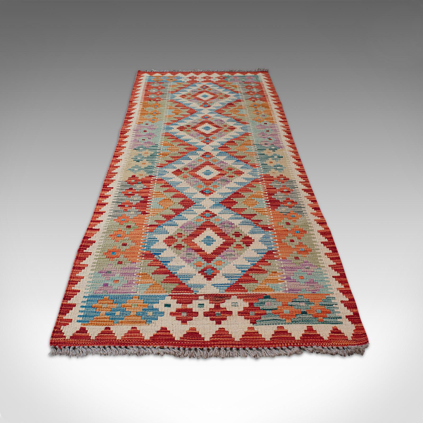This is a colorful vintage Choli Kilim runner. A Persian, handwoven, vegetable-dyed decorative hall carpet, dating to the mid-20th century, circa 1960.

A striking, versatile hallway runner at a size of 69cm (27.25'') x 206cm (81'')
Displaying a