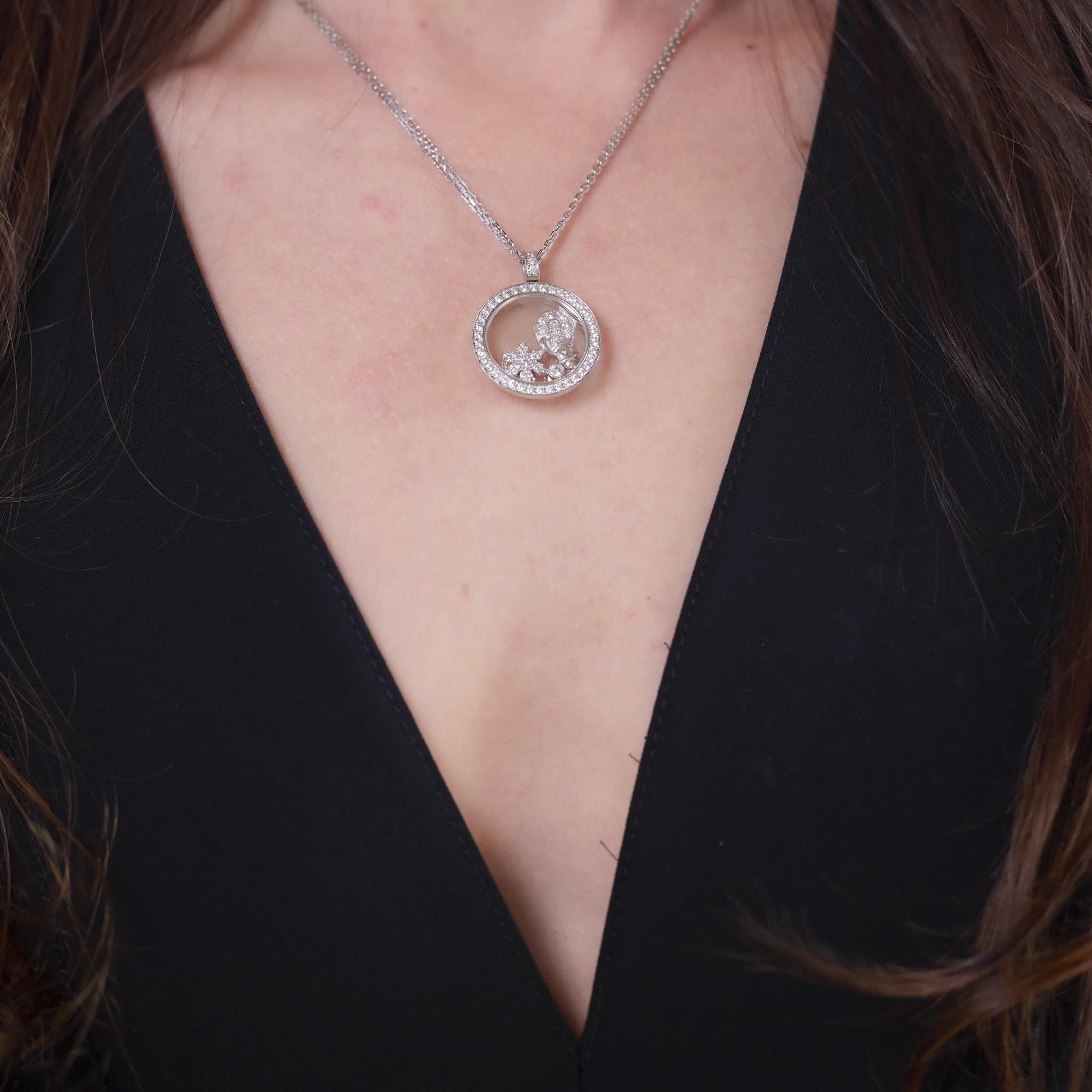 This vintage necklace by Chopard from the 1990s features 71 round brilliant cut diamonds totaling approximately 1.45 carats, graded D-E color and VS clarity. Crafted in 18k white gold, the pendant measures 1 x 1 inches and is suspended from a