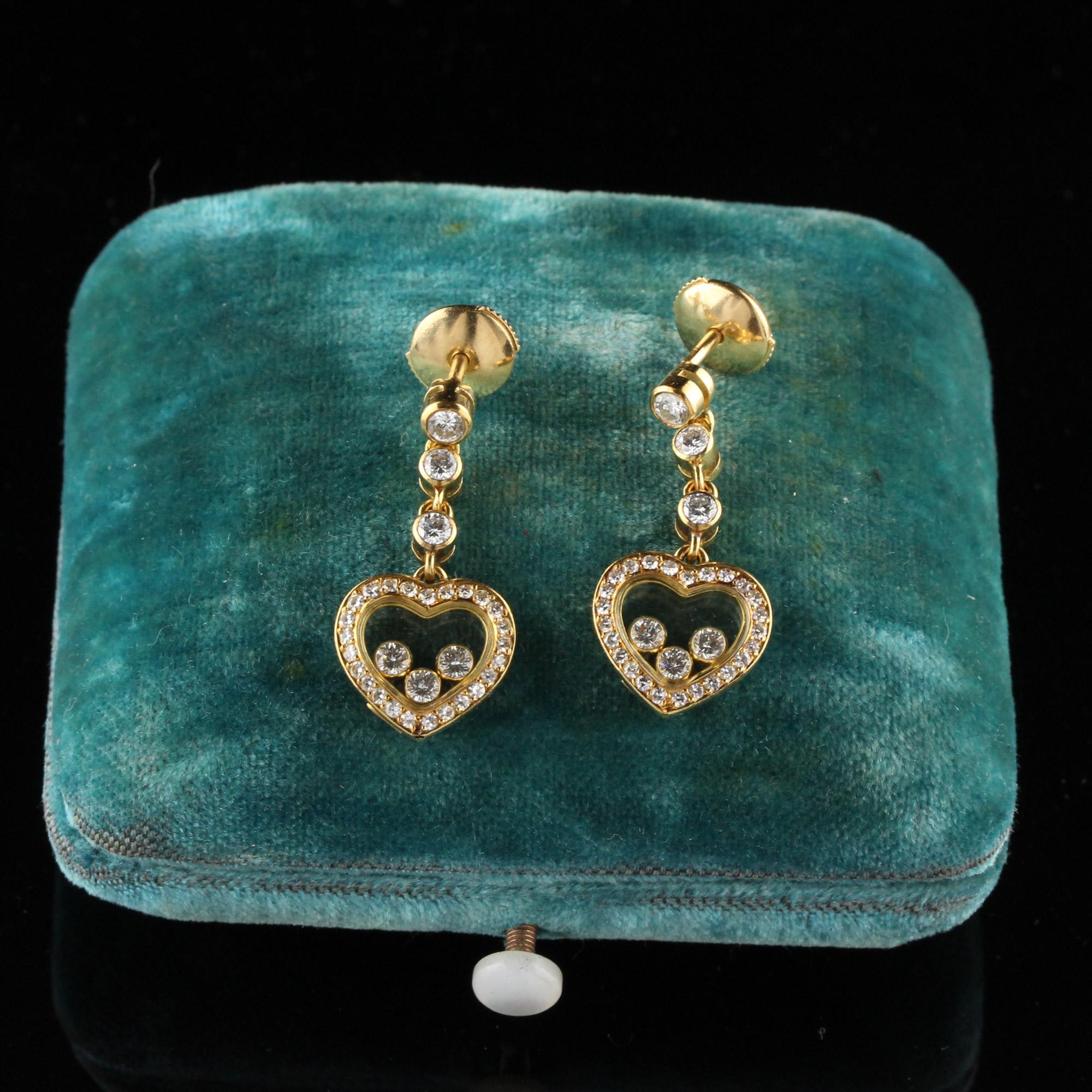 Beautiful Chopard Happy Heart drop earrings. Each heart earring contains 3 diamonds inside the heart. 

#E0008

Metal: 18K Yellow Gold

Weight: 6.8 Grams

Measurements: 11.9 x 10.7 mm

Drop Length: 25 mm