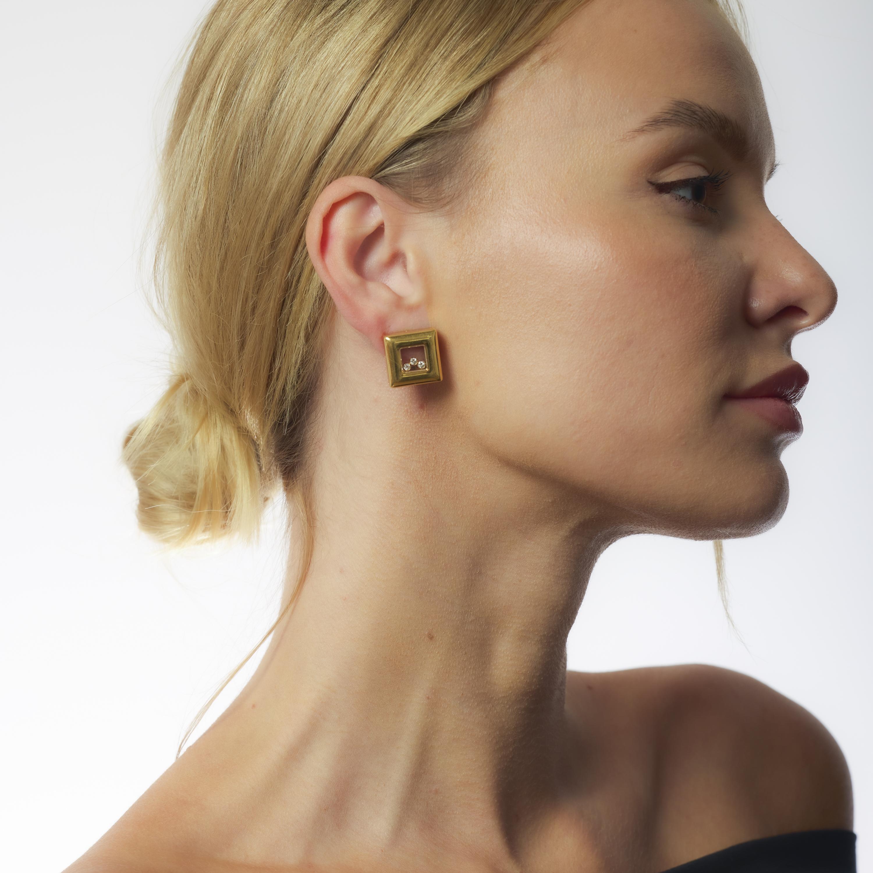 These vintage Chopard earrings are crafted in luxurious 18k yellow gold and set with four dazzling D-color, VS clarity diamonds. Signed and numbered, the 1990s design showcases the brand’s signature elegance in a bold, sculptural silhouette.