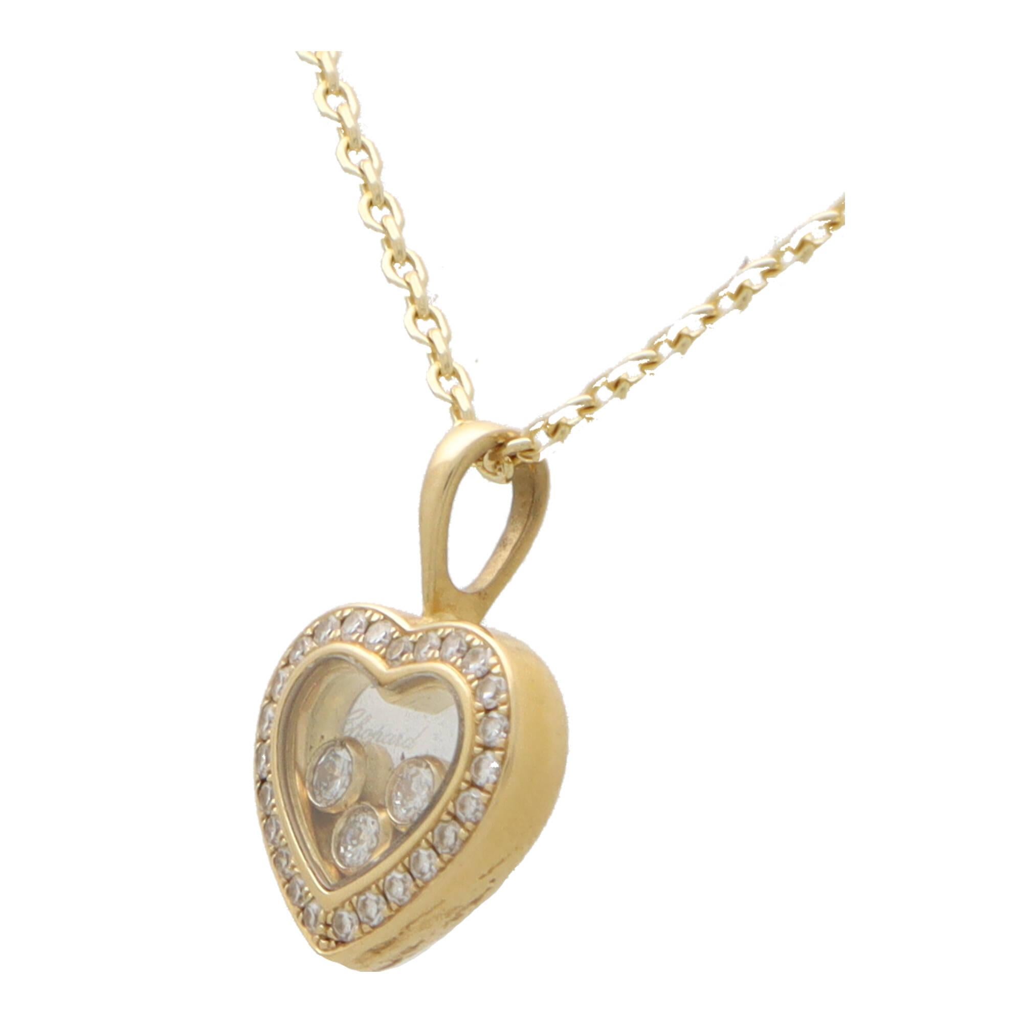 A stylish vintage Chopard ‘Happy Diamond’ pendant necklace set in 18k yellow gold.

The pendant is a discontinued design in the Happy Diamond collection and features a open-heart motif, with three floating rub over set diamonds in the centre. The
