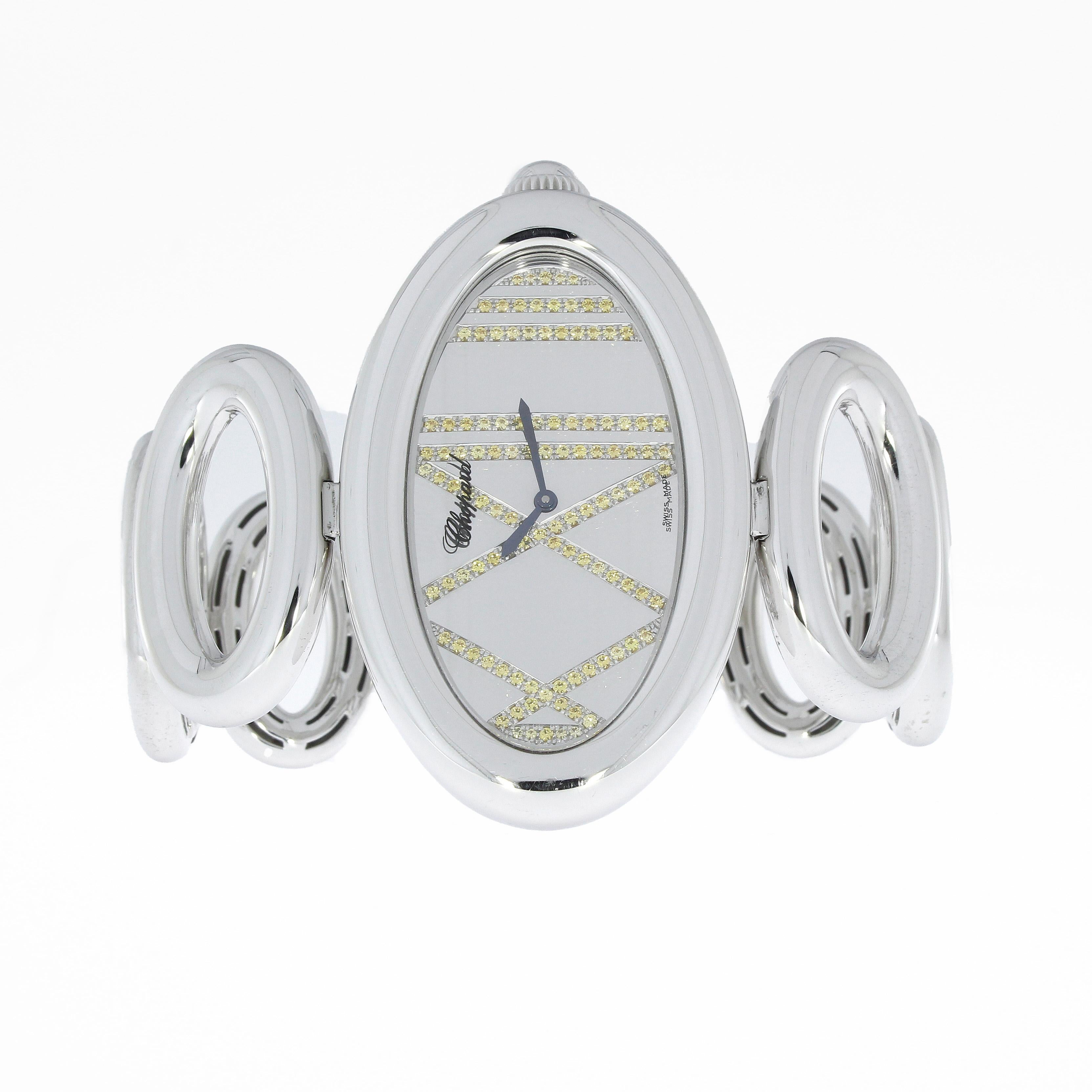 Oval Chopard Cat Eye Ladies Quartz Watch in 18k white gold and a beautiful silver dial with 111 yellow sapphires (0.87ct.)

Measurements: 55x35mm
Total length incl. bracelet - 190mm
Weight: 192gr.

