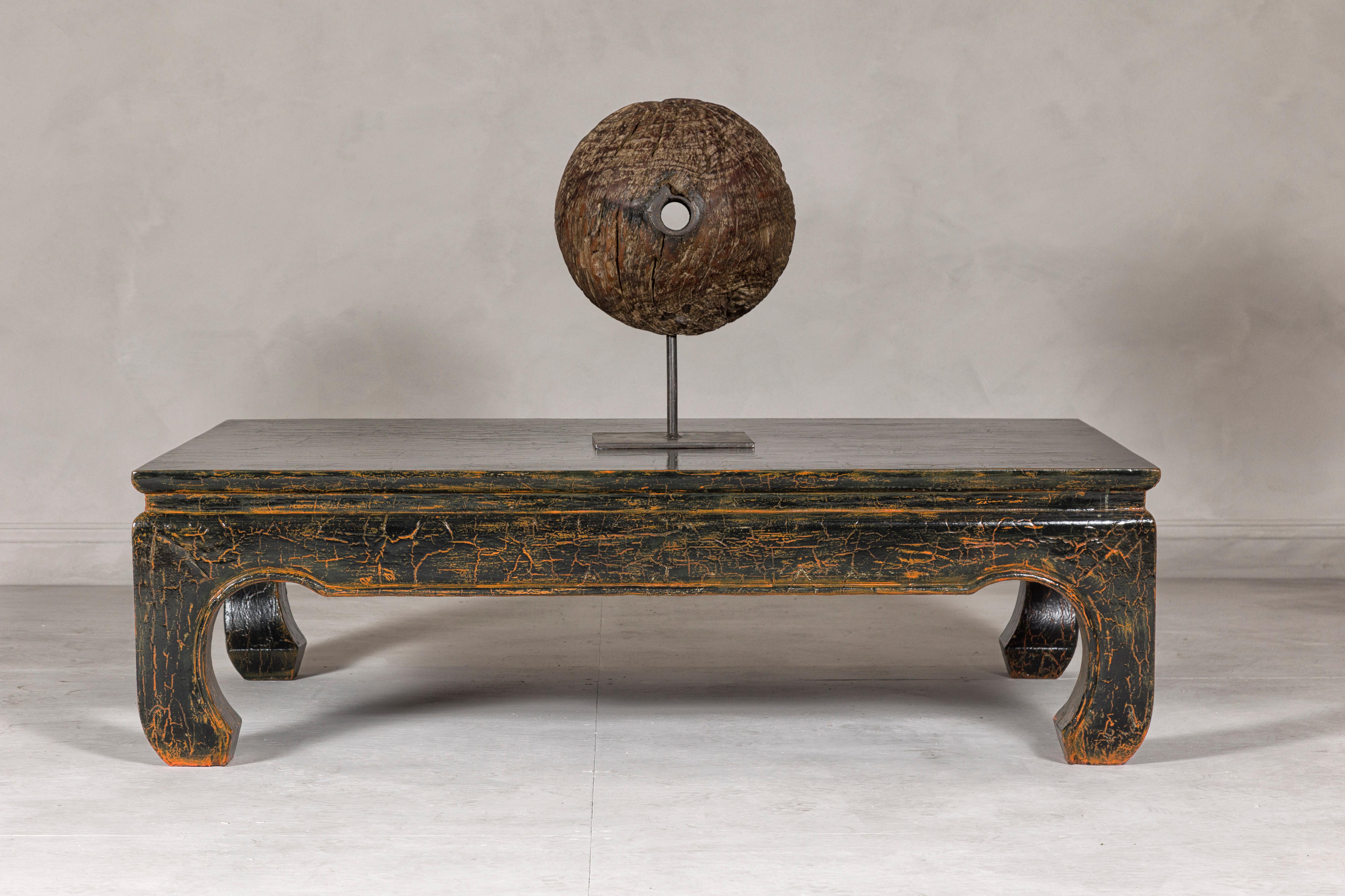 A vintage Chinese Ming Dynasty style distressed black chow legs coffee table with crackle orange finish. Step into a world where ancient elegance meets modern restoration with this vintage Chinese Ming Dynasty style coffee table. This exquisite