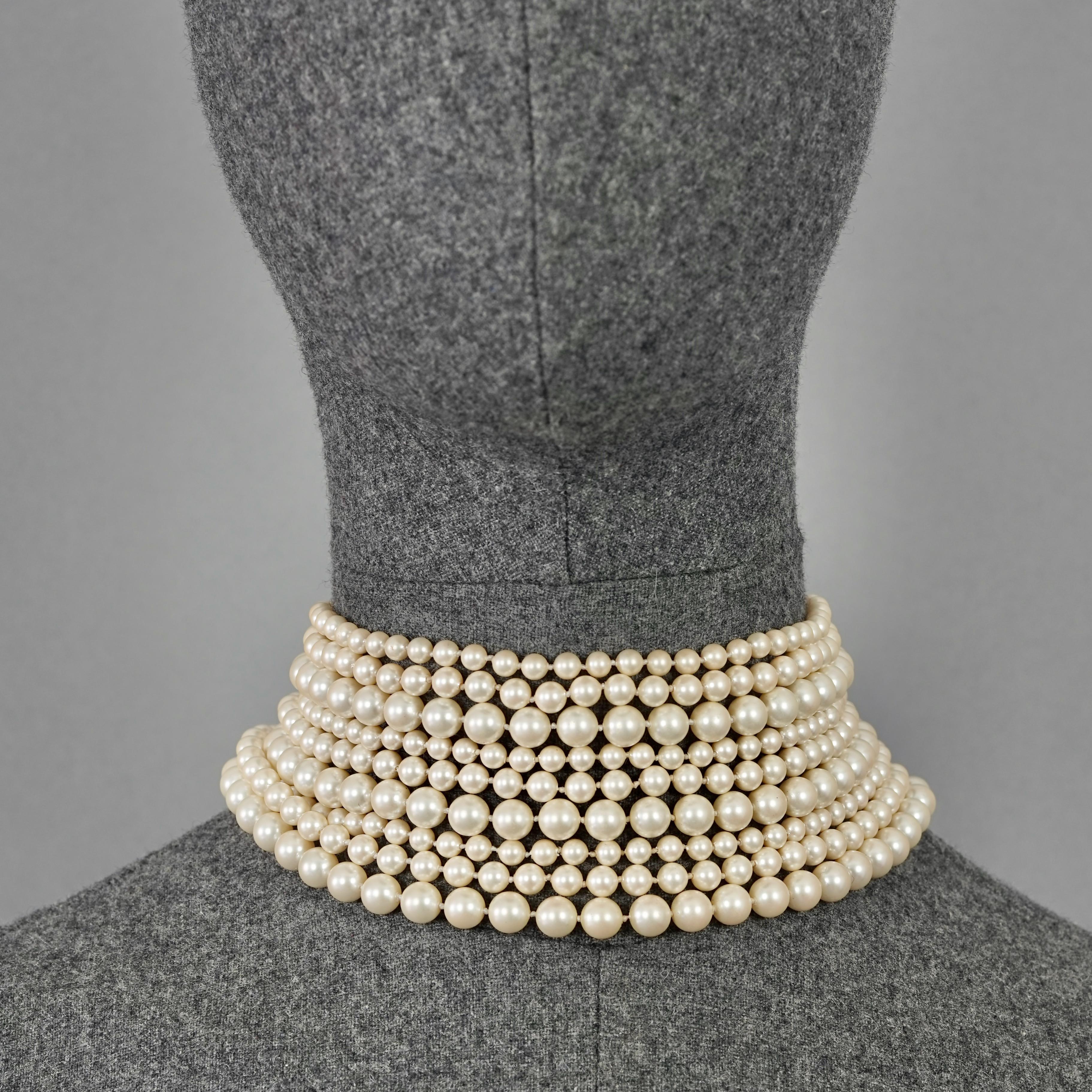 Vintage CHRISTIAN DIOR 9 Strand Pearl Choker Necklace

MEASUREMENTS:
Height: 2.95 inches (7.5 cm)
Wearable Length: 14.17 inches to 15.75 inches (36 cm to 40 cm)

FEATURES:
- 100% Authentic CHRISTIAN DIOR.
- Choker with 9 multi strand pearls.
- Gold