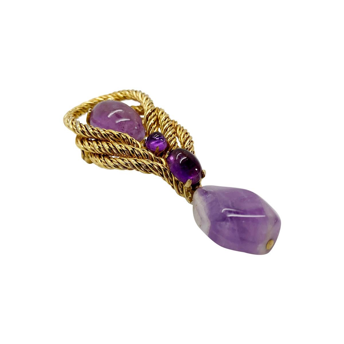 A sublime vintage Dior Amethyst Brooch. Large, tumbled amethyst stones and cabochons sit amongst twisted golden hoops to create a beautifully elegant design. With archive pieces from her own Dior collection displayed in London's highly acclaimed