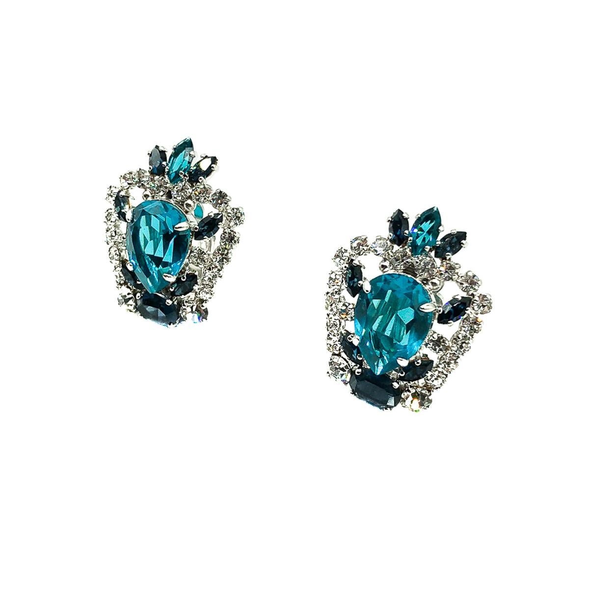 A pair of Vintage Dior Aqua Blue Earrings crafted by the House in the year of 1970 with Marc Bohan at the helm. Crafted in rhodium plated metal with an array of claw set crystals. Featuring a crown inspired design set with a large deep aqua teardrop