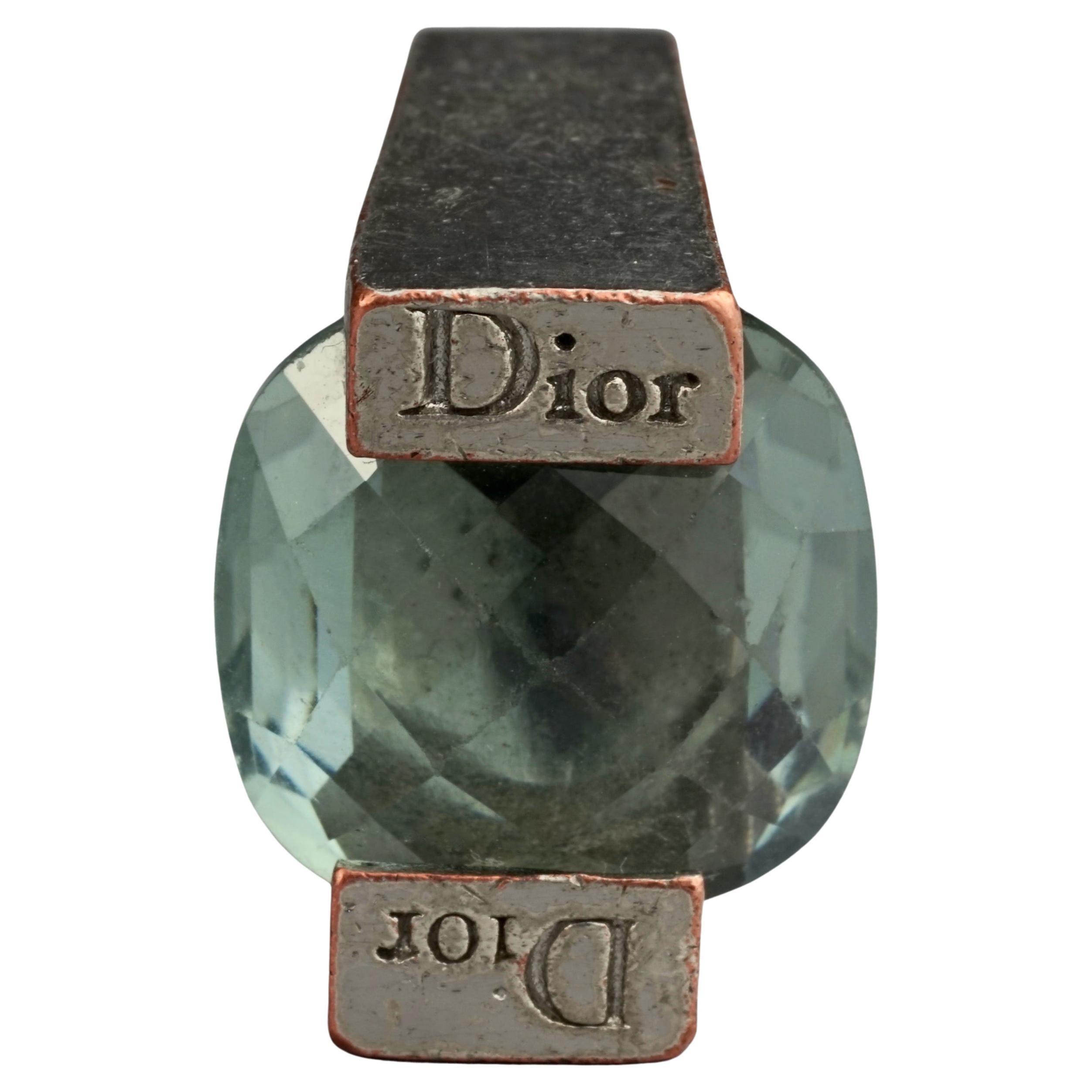 Vintage CHRISTIAN DIOR Aquamarine Art Deco Ring

Measurements:
SIZE: 52
Face Height: 0.63 inch (1.6 cm)
Face Width: 0.78 inch (2 cm)

Features:
- 100% Authentic CHRISTIAN DIOR.
- Arte deco ring with faceted aquamarine glass stone.
- Engraved DIOR on