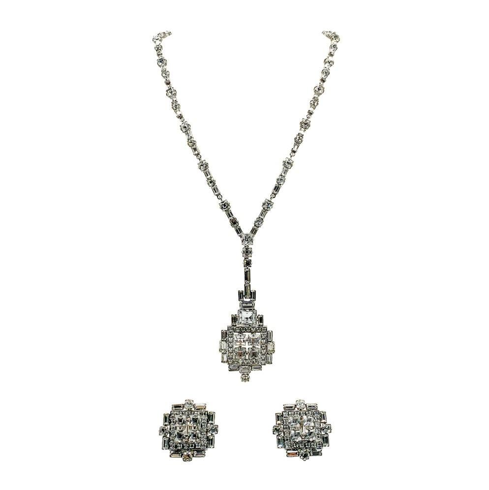 A totally timeless vintage Dior Deco necklace and earrings or demi-parure. Featuring an incredible array of fancy cut crystals tantalisingly set in an Art Deco style design setting. The very long and lavish pendant drops away from a long crystal set