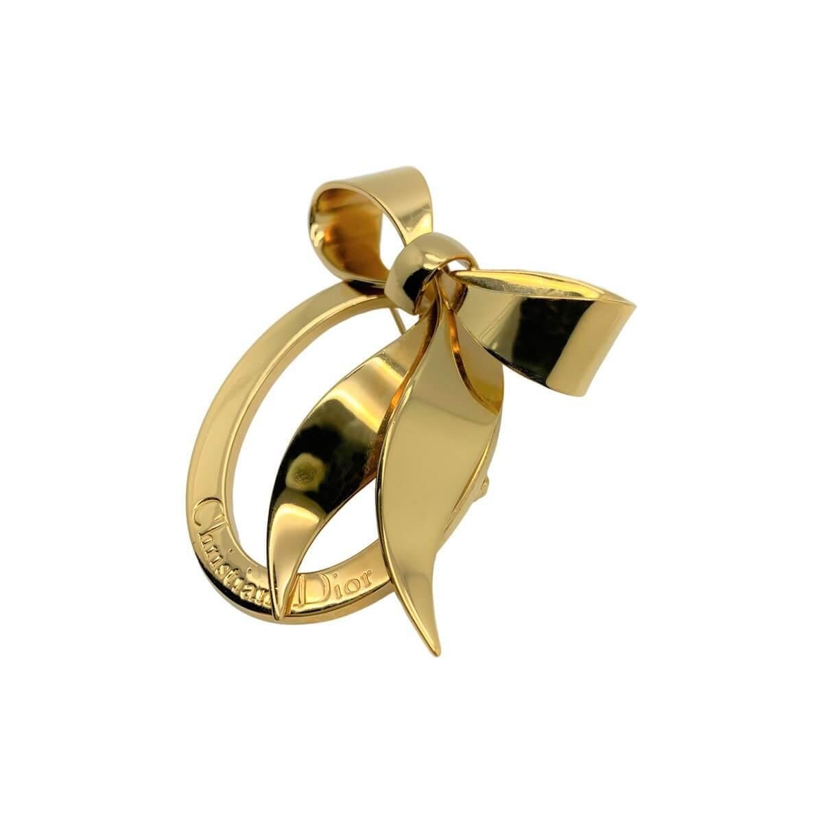 A heavenly vintage Dior bow brooch. Featuring a large oval embellished with the name of the iconic House of Dior and finished top perfection with a large stylised floppy bow, one of fashions greatest and most timeless motifs.
With archive pieces