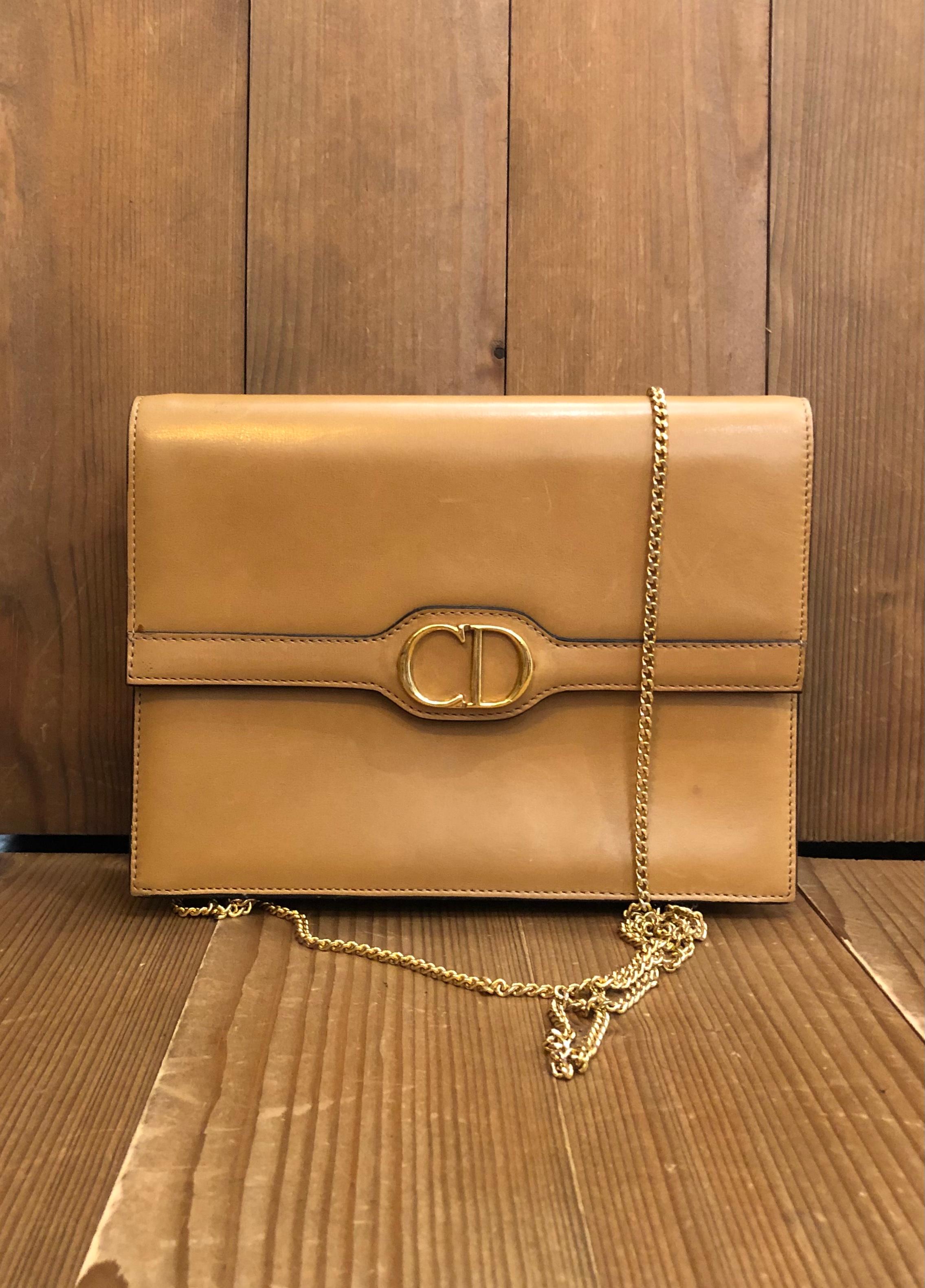 This vintage CHRISTIAN DIOR small box bag is crafted of smooth calfskin leather in beige. This vintage Dior features a detachable Dior gold toned chain allowing you to carry it as a crossbody bag or as a clutch. Front flap magnetic snap closure