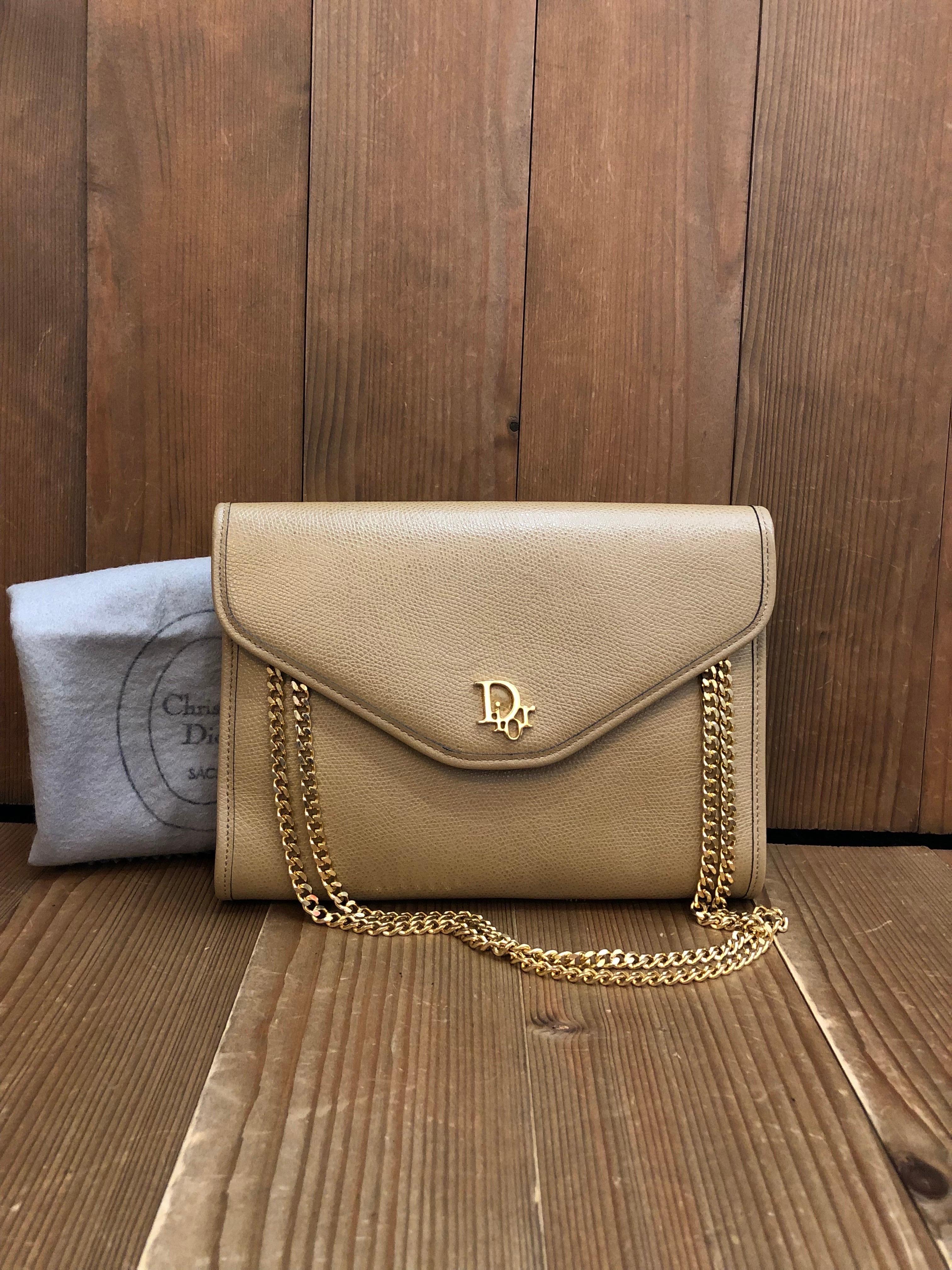 This vintage CHRISTIAN DIOR shoulder bag is crafted of grain-textured leather in beige. This vintage Dior features a gold toned chain that lets you carry it single and double chained or as a clutch. Front flap closure with snap fastening opens to a