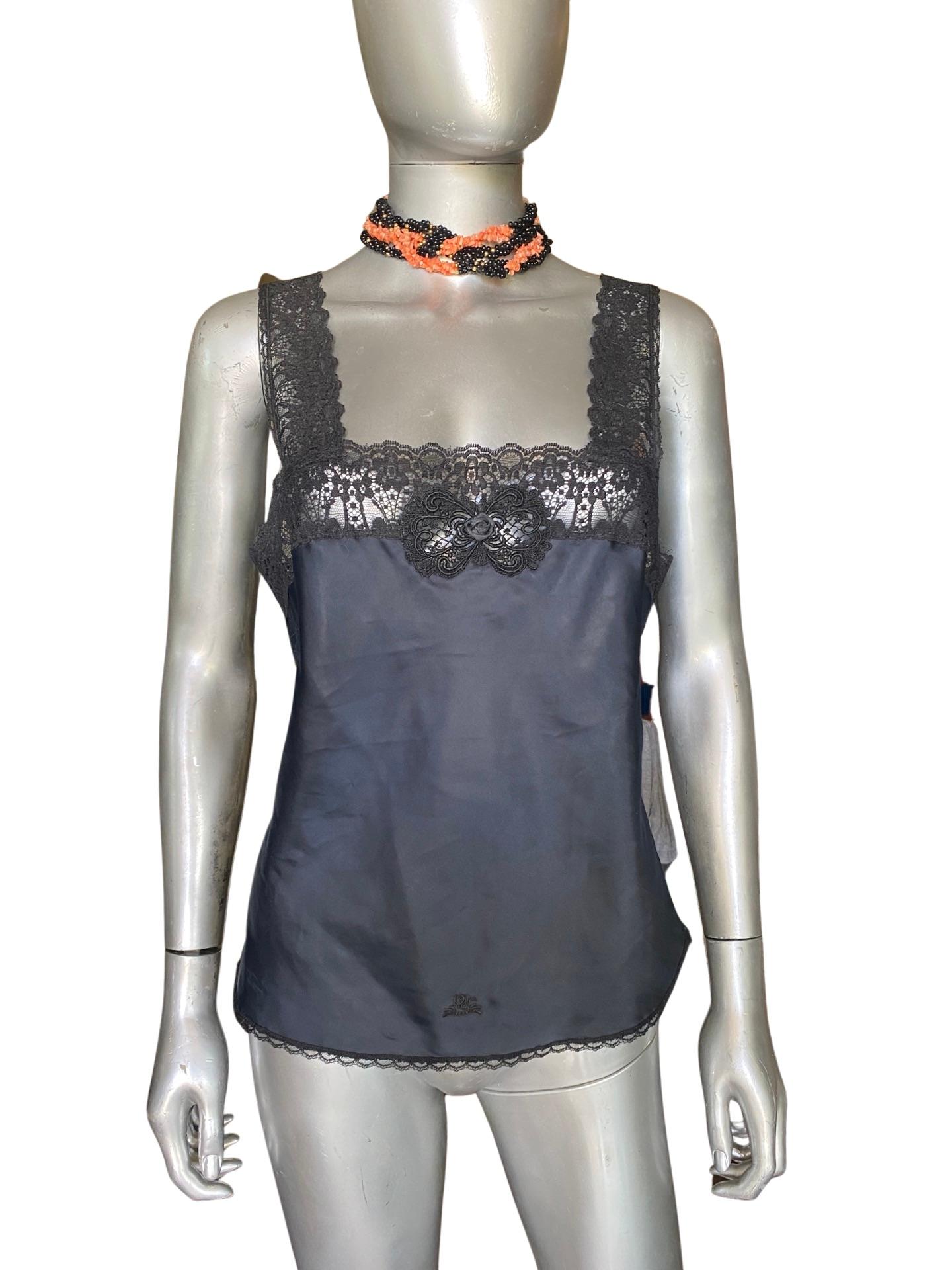 They don't make them like this anymore. A Christian Dior Camisole (a modern blouse) has the most beautiful imported black lace. Body is silk look made in a nylon/rayon/poly blend that is even machine washable. Beautiful small hand made rosette on