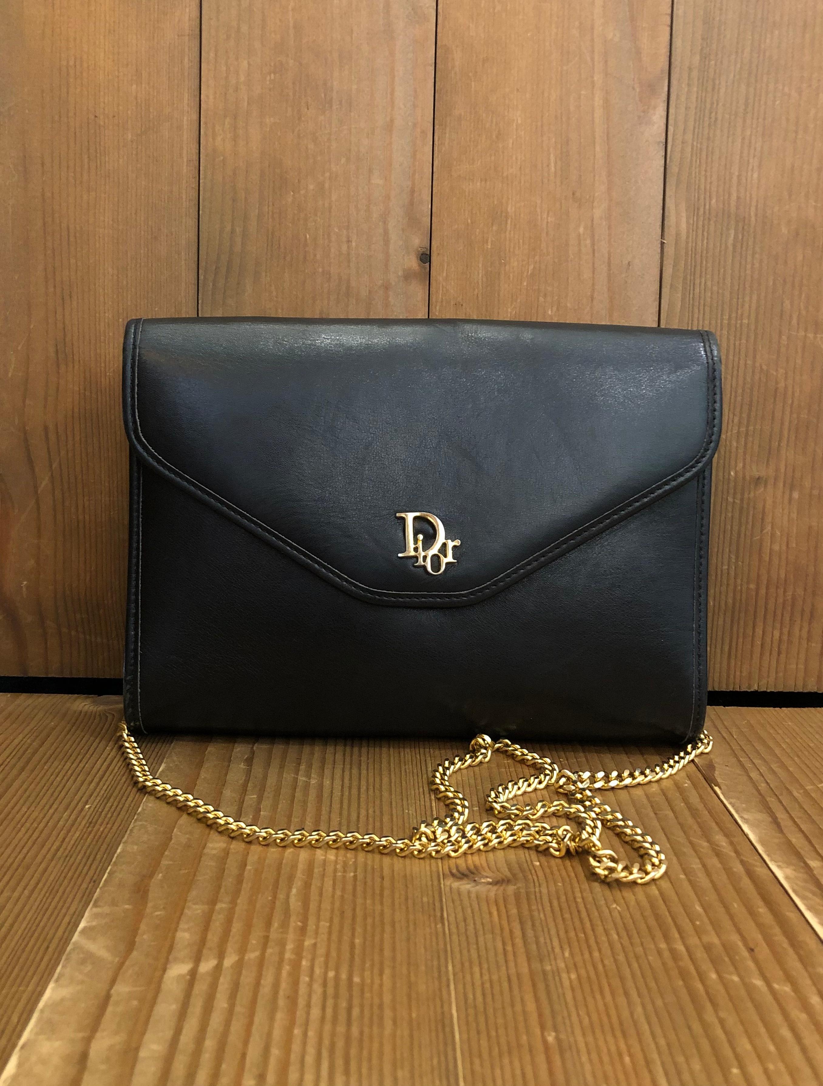 This vintage CHRISTIAN DIOR chain shoulder bag is crafted of smooth leather in black with gold toned hardware. This Dior features a gold toned chain that lets you carry it single/double chained or as a clutch. Front flap closure with snap fastening