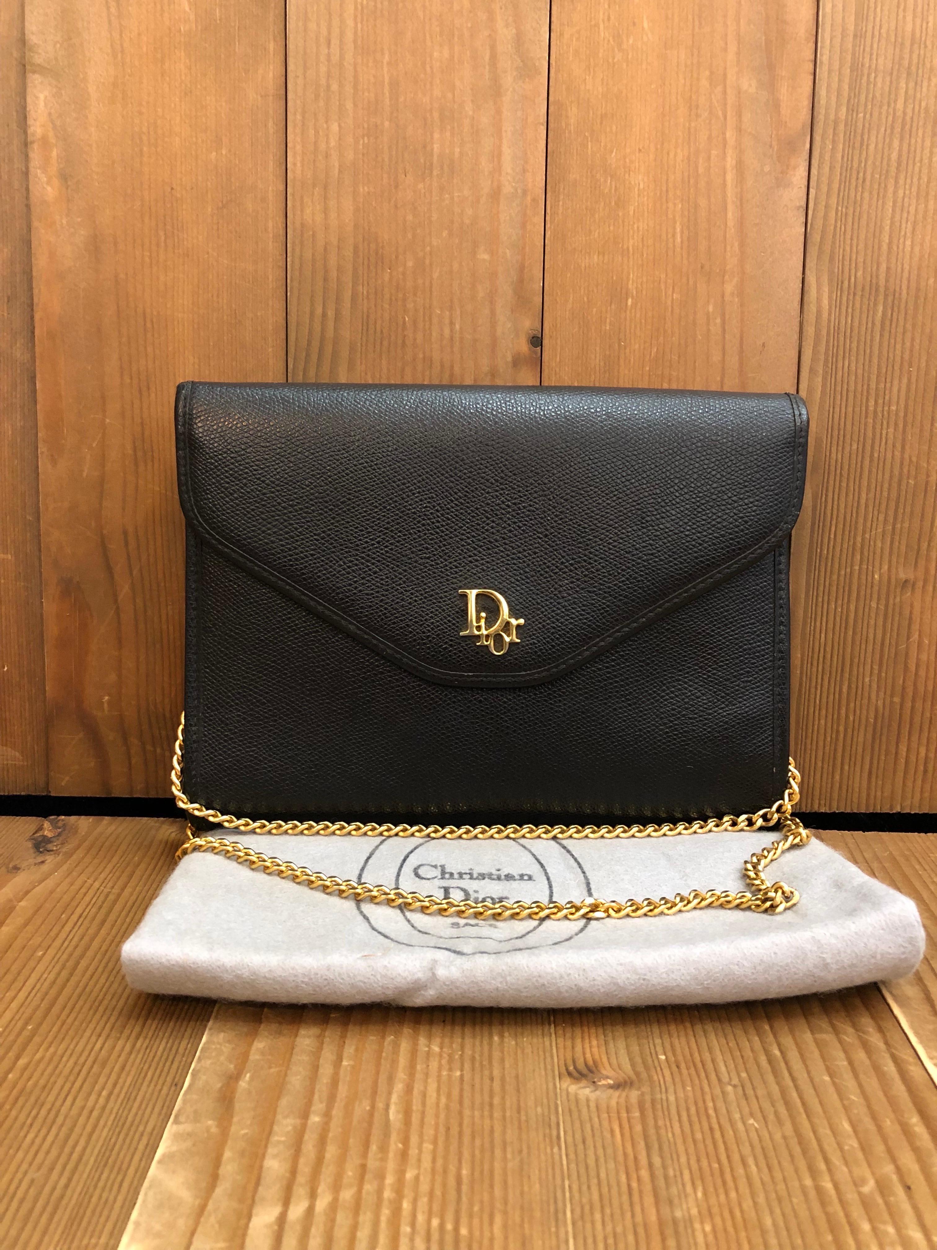 This vintage CHRISTIAN DIOR shoulder bag is crafted of grain-textured leather in black. This vintage Dior features a gold toned chain that lets you carry it single and double chained or as a clutch. Front flap closure with snap fastening opens to a