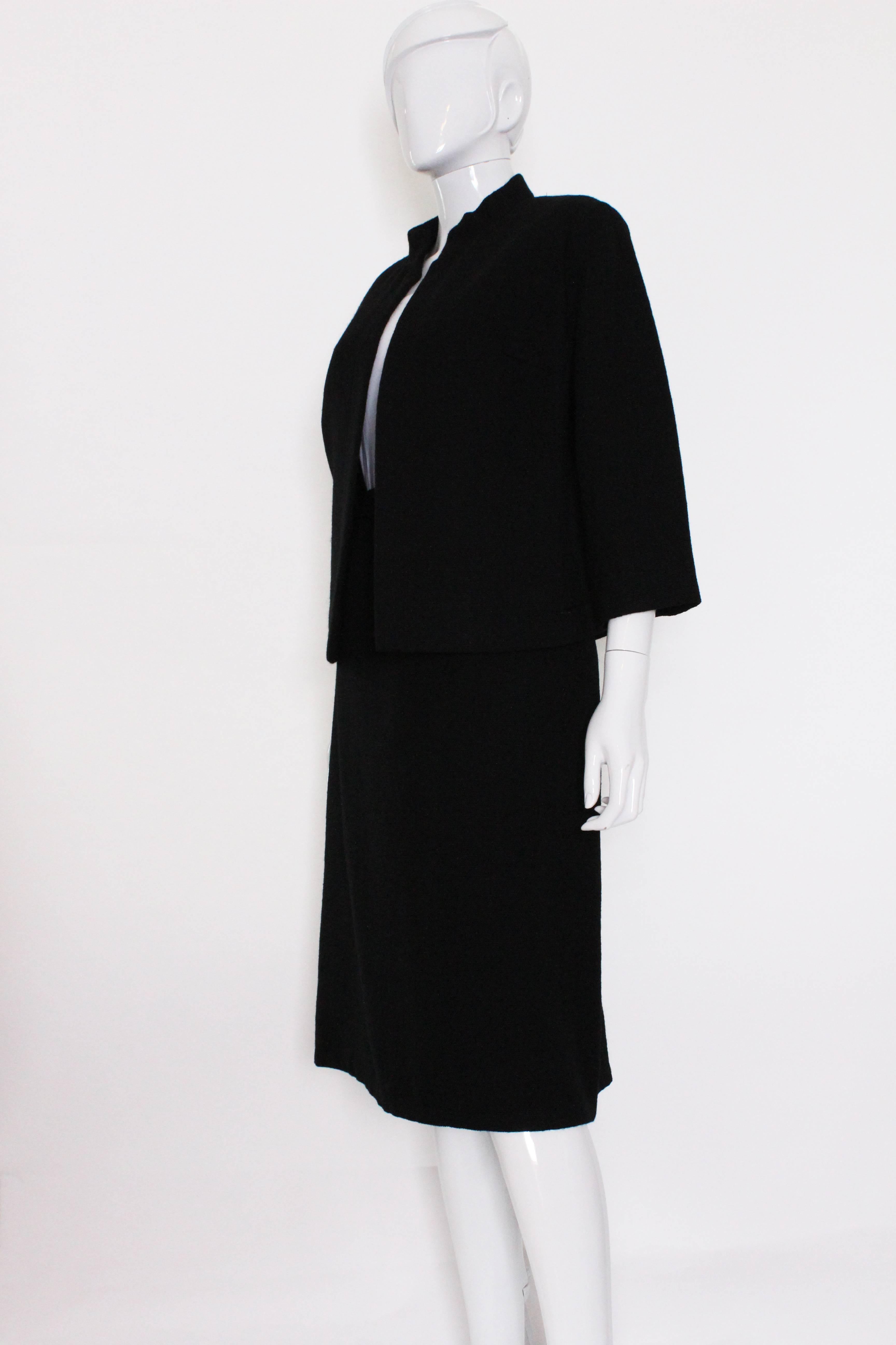 A charming and chic suit by Christian Dior. A numbered , 49839 , Dior, Christian Dior London Suit.The jacket has a mandarin collar and elbow length sleeves and no fastening.The skirt is A line, with a central back zip.
The jacket is bust up to
