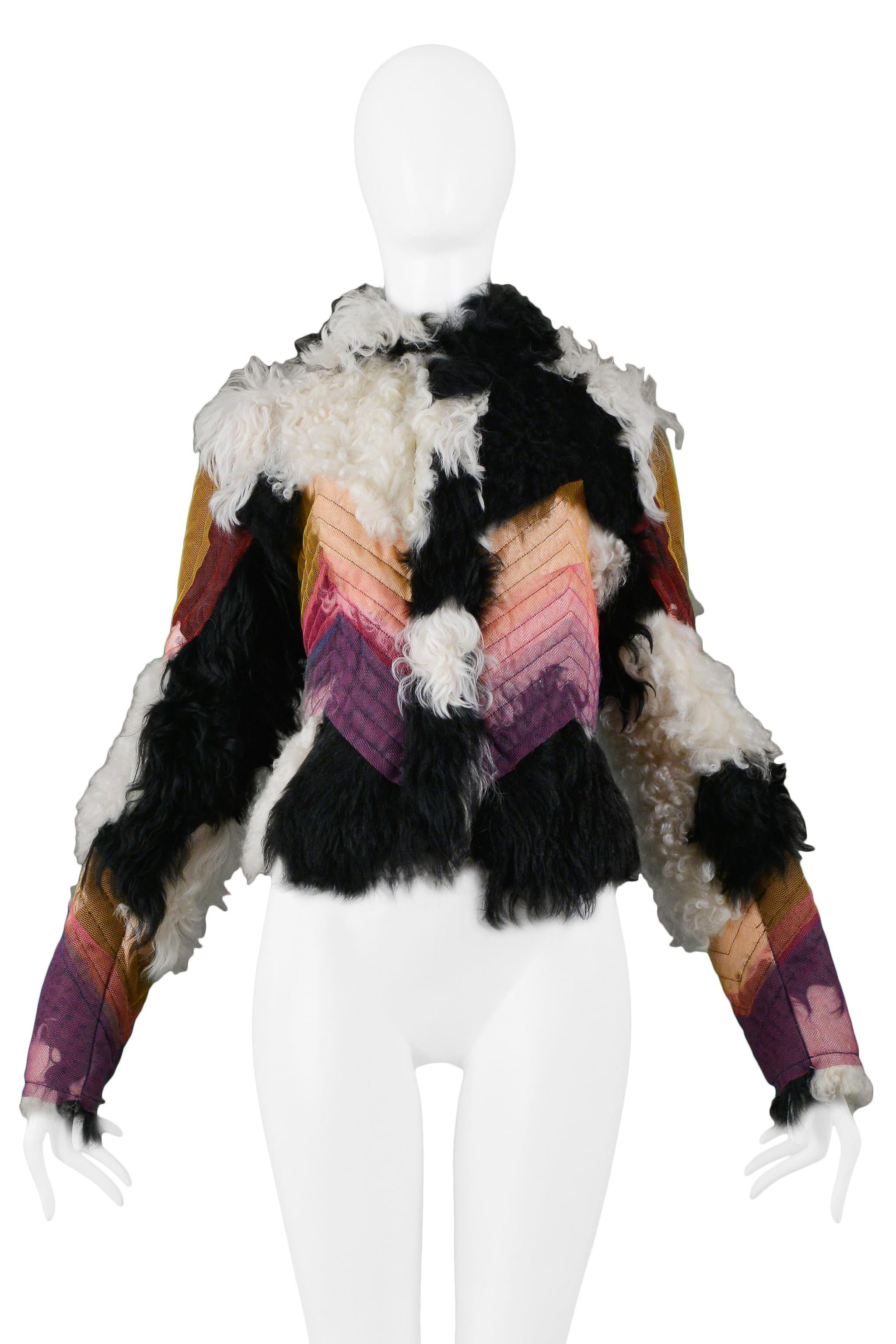 Vintage Christian Dior black and white lamb shearling jacket featuring a multicolor sheer panel overlay at front and back waist and sleeves with chevron stitching. Collection 2001.

Excellent Vintage Condition.

Size: 38

Measurements: Shoulder