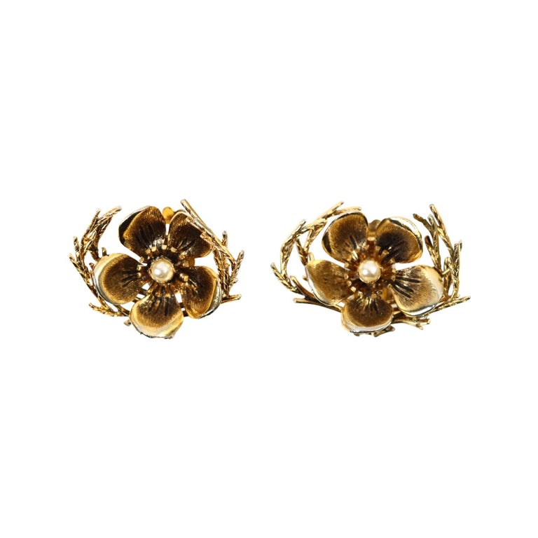 Vintage Christian Dior Boutique Gold Flower with Faux Pearl Circa 1964.  Gold Tone Flowers with Faux Pearls surrounded by branches on either side. Clip On.  In great condition and such special earrings

These will always be in style.