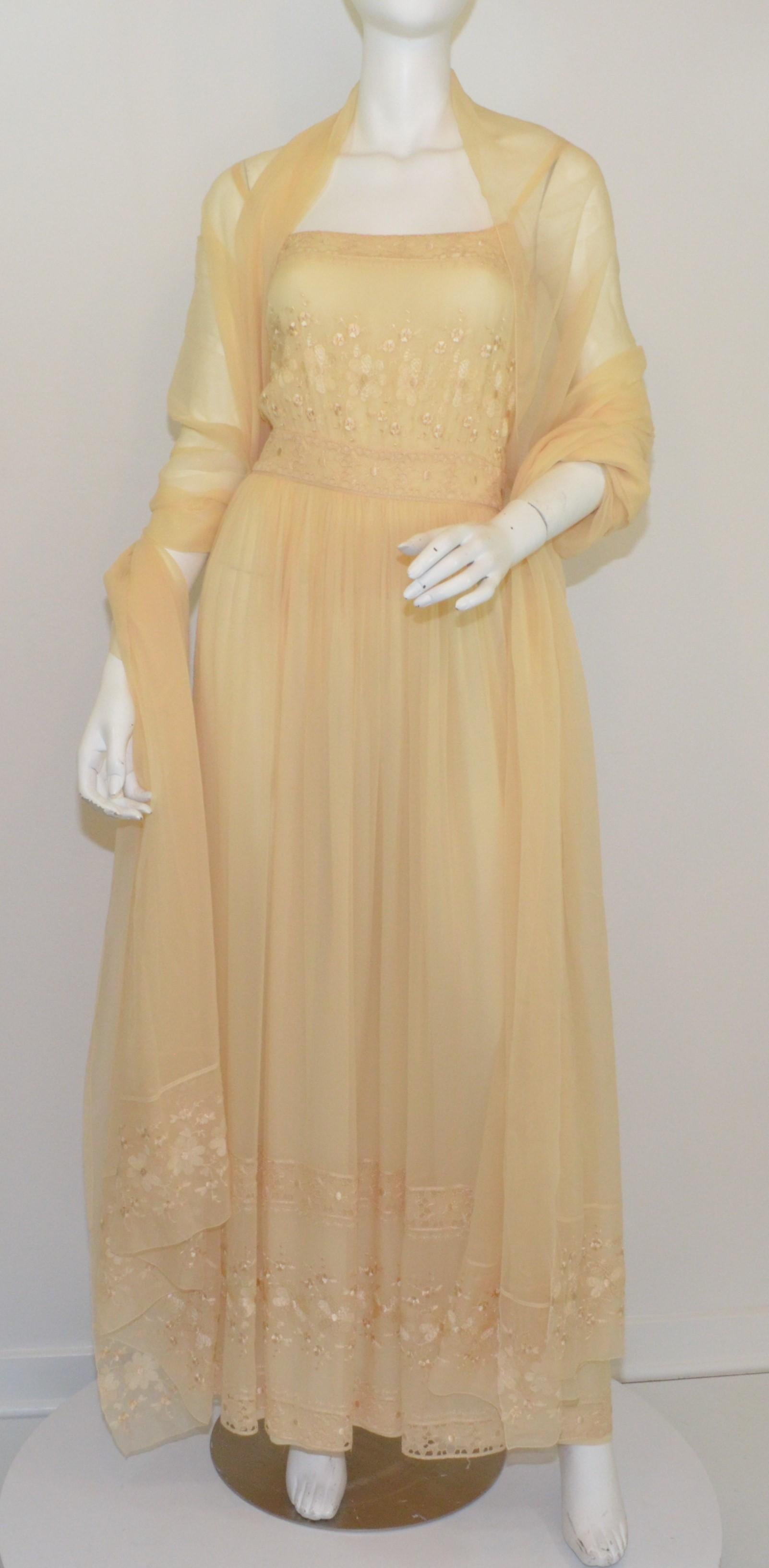 This beautiful Christian Dior boutique gown is featured in a beige color composed with silk chiffon with a floral eyelet detail along the bodice and side panels. Dress has flat shoulder straps and a side zipper fastening. Dress is fully lined and