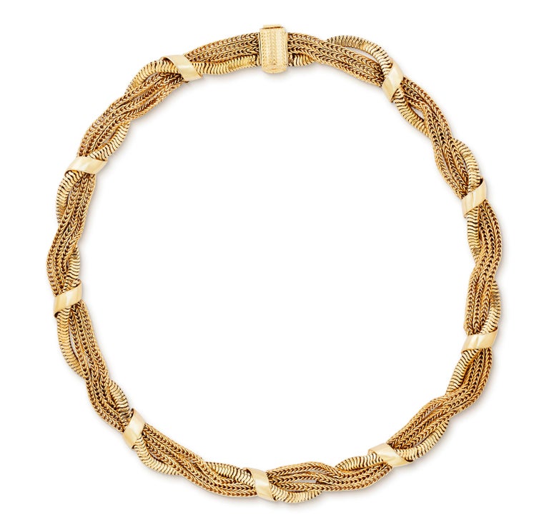 Vintage 1958 Christian Dior braided chain necklace in gold plate.  This heritage necklace comprises four chains twisted together and held in place with polished elements to create a decorative draped, braided look.  The necklace sits at choker