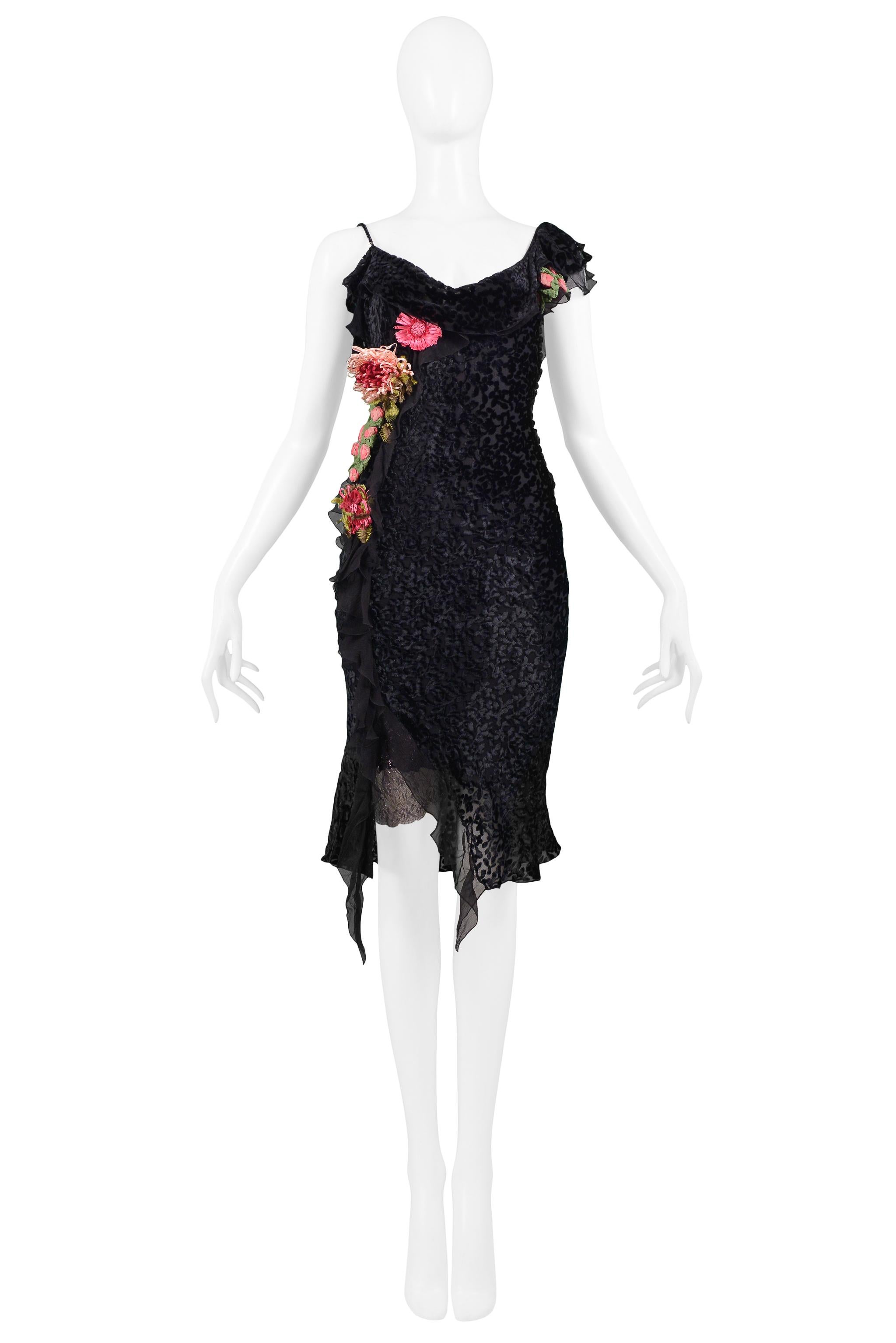 Resurrection Vintage is excited to offer a vintage Christian Dior black Devore velvet bias-cut dress featuring a draped neckline, spaghetti straps, pink and green raffia flowers at the waist, cocktail length, and asymmetrical ruffle accents at