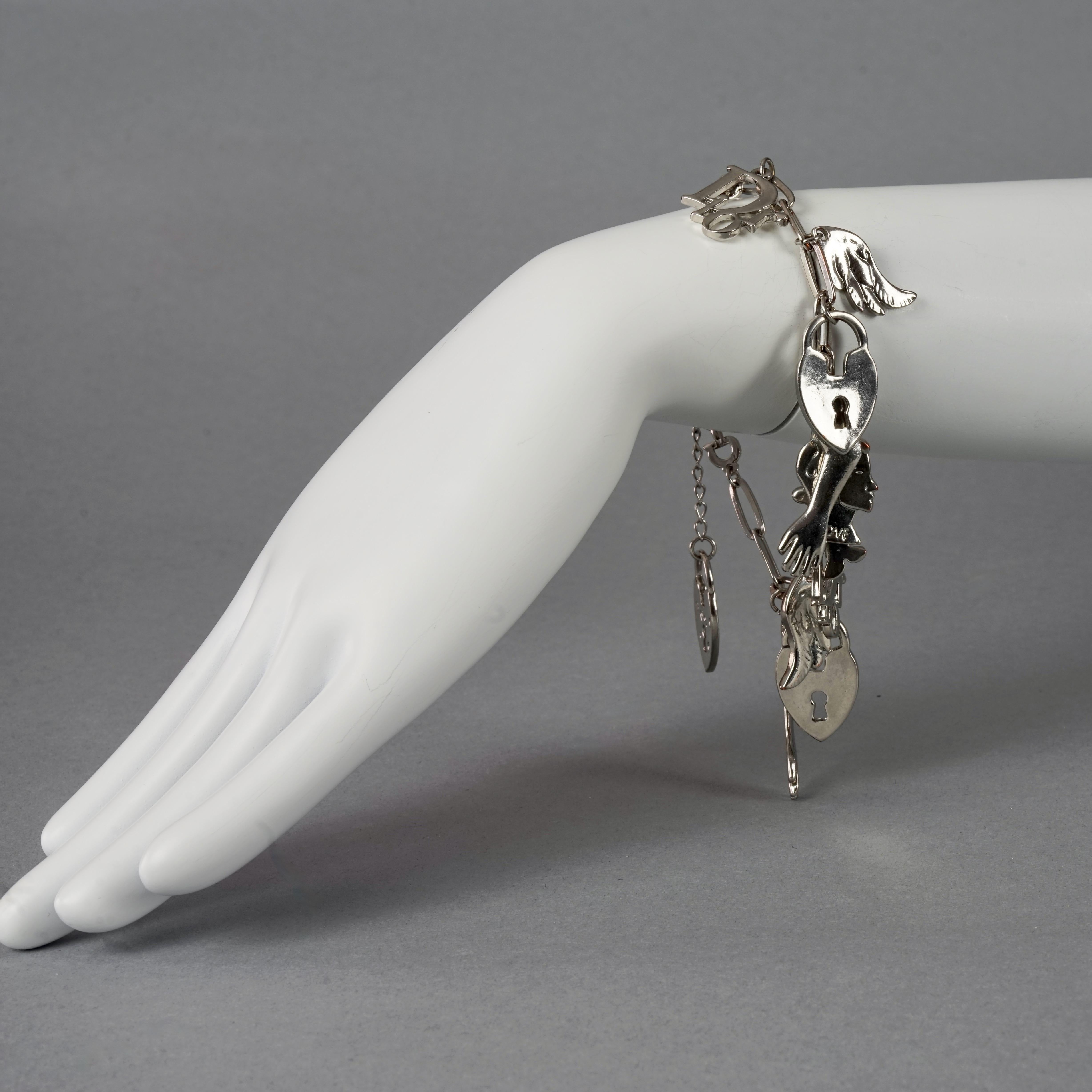 Vintage CHRISTIAN DIOR by GALLIANO Figural Charm Silver Bracelet

Measurements:
Height: 1.77 inches (4.5 cm)
Total Wearable Length: 9.84 inches (25 cm) adjustable

Features:
- 100% Authentic CHRISTIAN DIOR by John Galliano.
- Chain bracelet with