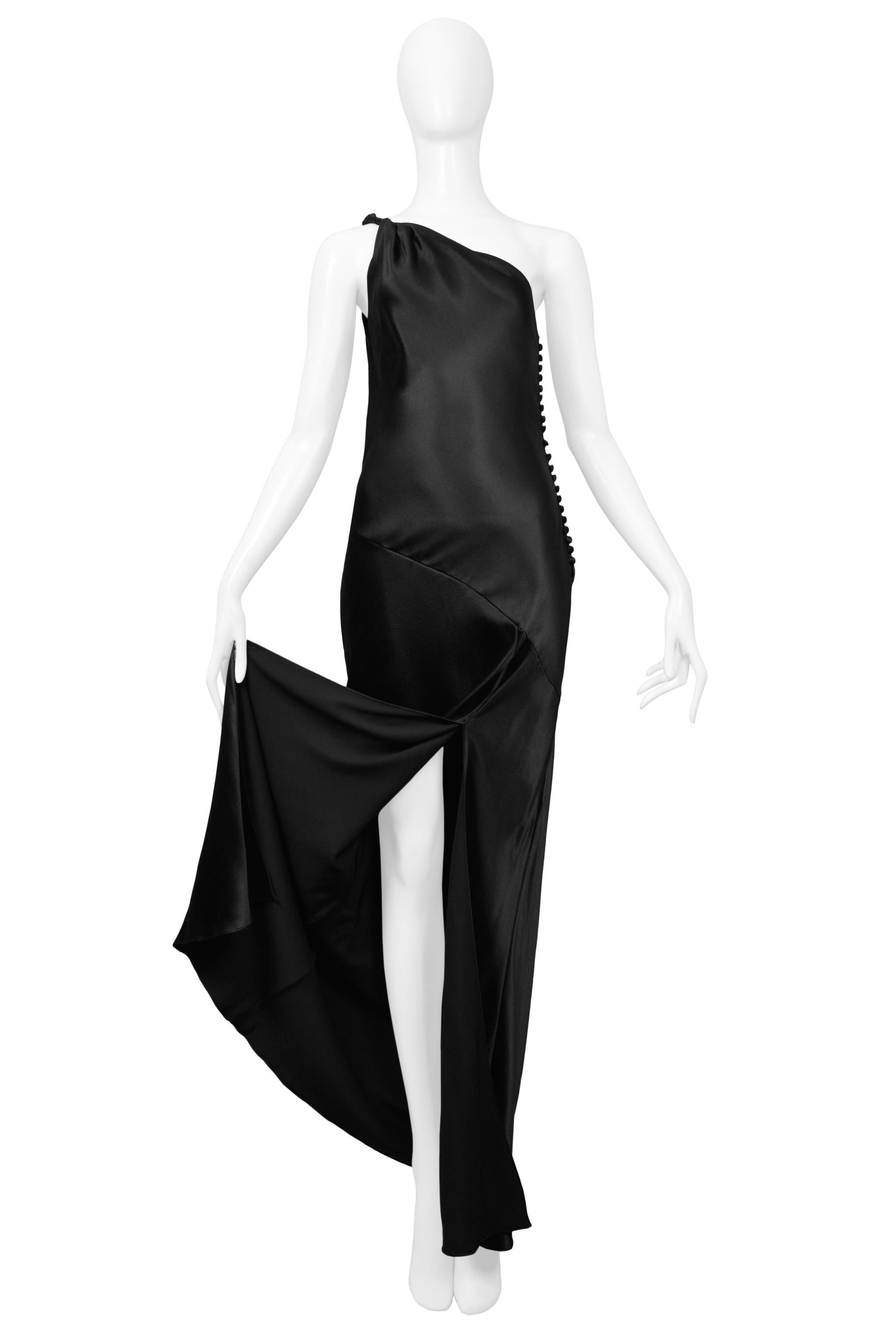 Resurrection Vintage is pleased to offer a vintage Christian Dior by John Galliano black silk asymmetrical bias cut gown featuring side button closure and a dramatic front slit. 

John Galliano 
Size 36
2001 Collection
Satin
Excellent Vintage