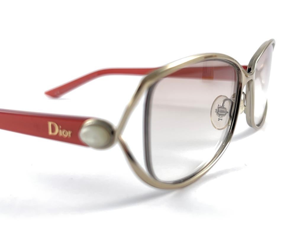 
Classy And Eye Catching Vintage Christian Dior CD 3728 Silver & Red With Pearls Accents Frame Holding A Pair Of Gradient Light Grey Lenses Sunglasses.

New! Never Worn Or Displayed


This Item May Show Minor Sign Of Wear Due To Storage.



Made In