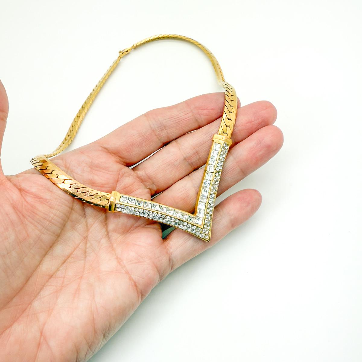 A chunkier version of this Dior design, this striking vintage Dior V necklace is expertly crafted to showcase the House’s timeless style. This bold and weighty statement piece features classic chain links flowing into a dramatic V-shaped panel, set