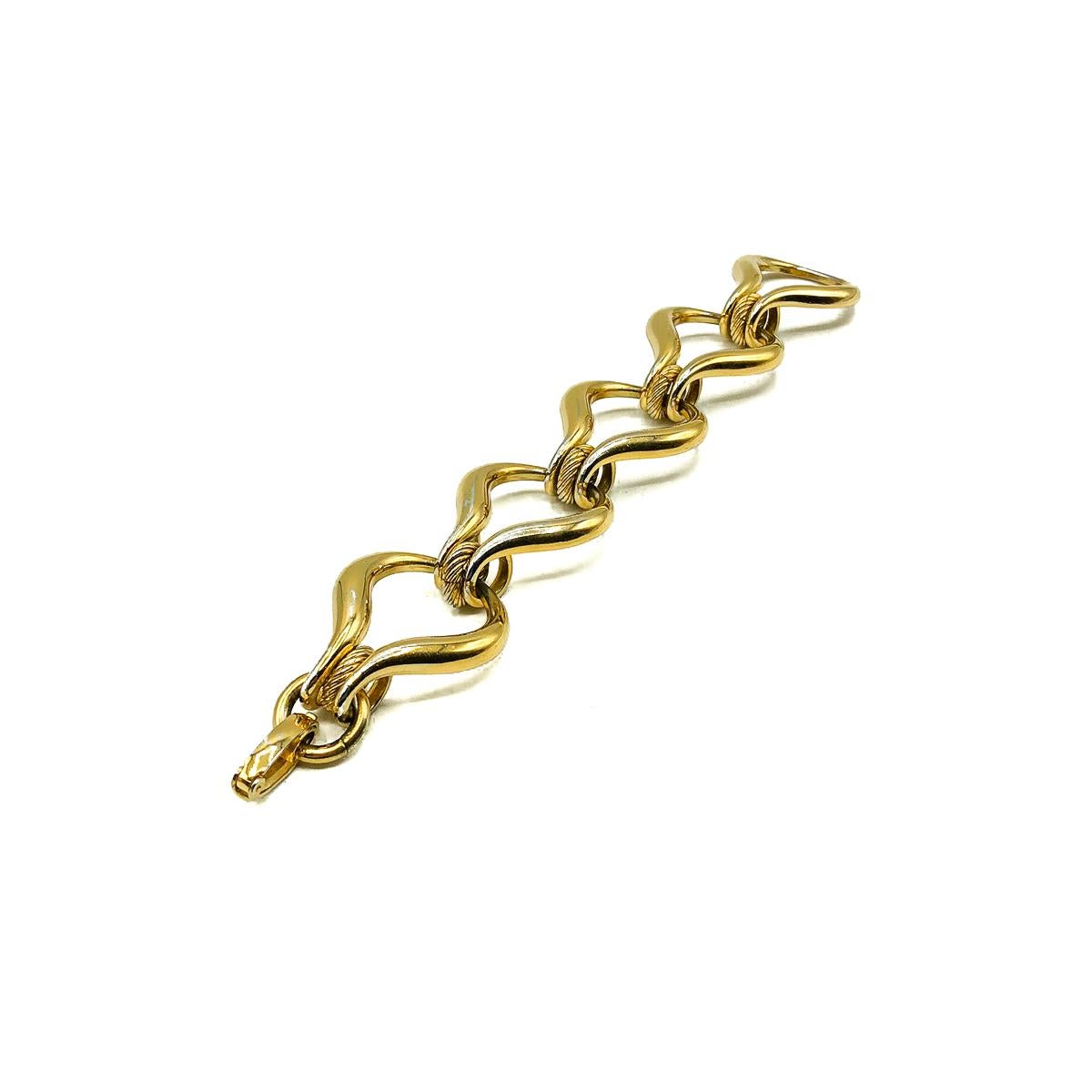 A Vintage Dior Link Bracelet. Crafted in gold plated metal. Featuring large stylised links with rope twist detailing. In good vintage condition with small amounts of light wear to the gold plating, signed and approx. 19cm by 3cm wide. An uber chic