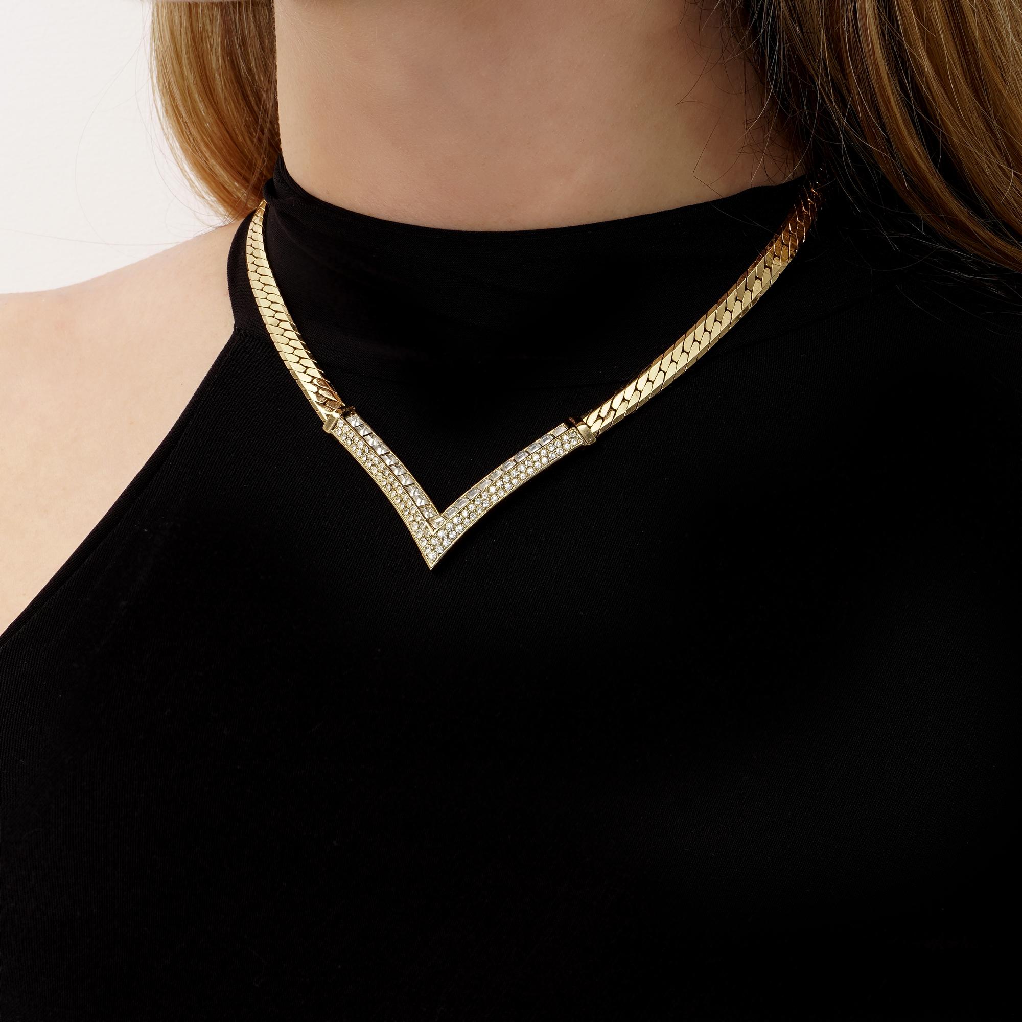 Indulge in the timeless elegance of this Vintage Christian Dior Crystal Arrow Triangle Pendant Collar Necklace, a stunning piece crafted circa the 1980s, exuding the sophistication and glamour synonymous with the Dior brand.

This exquisite necklace