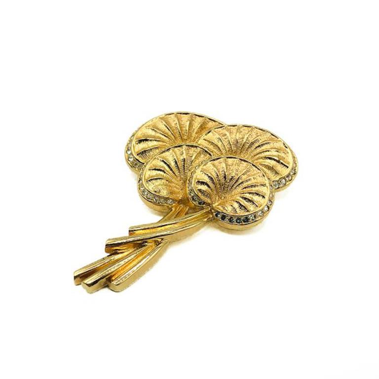 A stylish Vintage Dior Palm Leaf Brooch. Crafted gold plated metal and embellished with pave set chaton crystal stones. In very good vintage condition, signed, 7cms. A wonderfully wearable classic from the House of Dior. Should you choose to buy