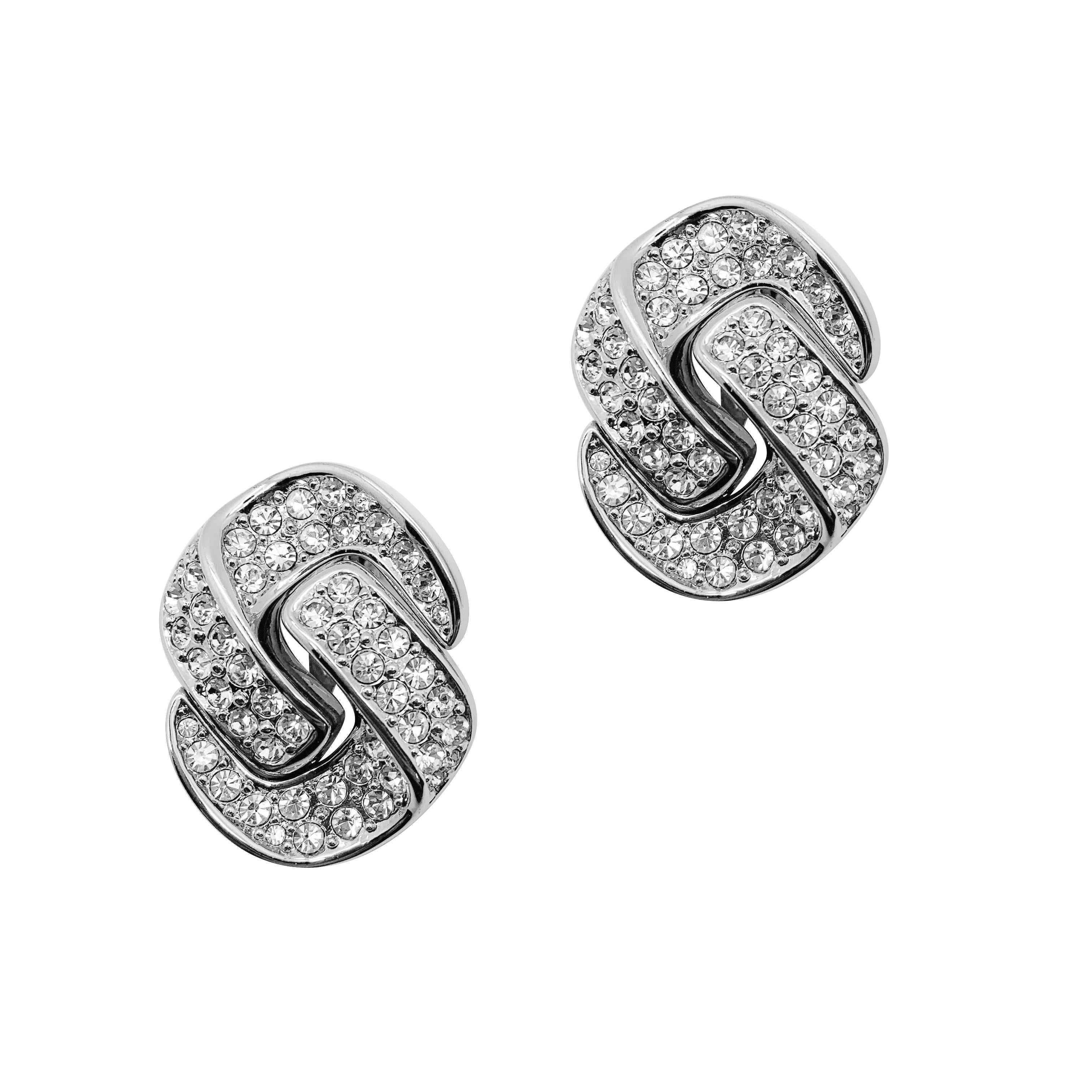 Our Vintage Dior Knot Earrings. A stunningly glamorous crystal encrusted knot style clip-on earring from the House of Dior. Pave set crystals adorn this contemporary style motif for maximum glampact. From the House of Christian Dior during the