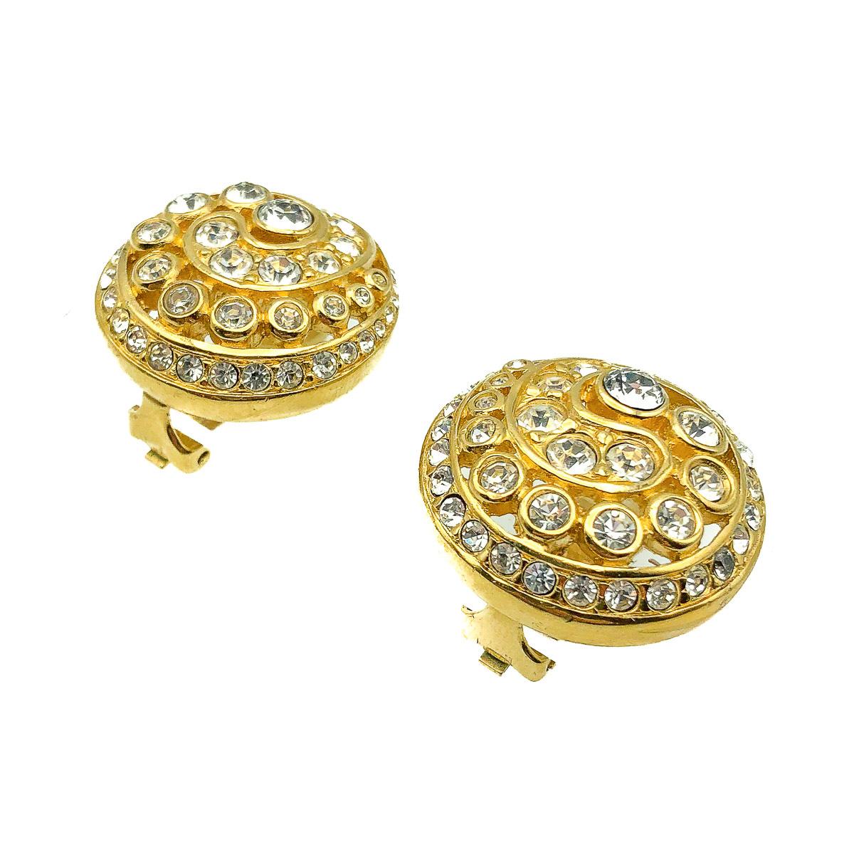 Vintage Dior Crystal Swirl Earrings. Crafted in gold plated metal and set with crystal chatons in a graduating swirl. In very good vintage condition. Signed. Approx. 2.7cms. A glamourous pair of earrings from the House of Dior that will undoubtedly