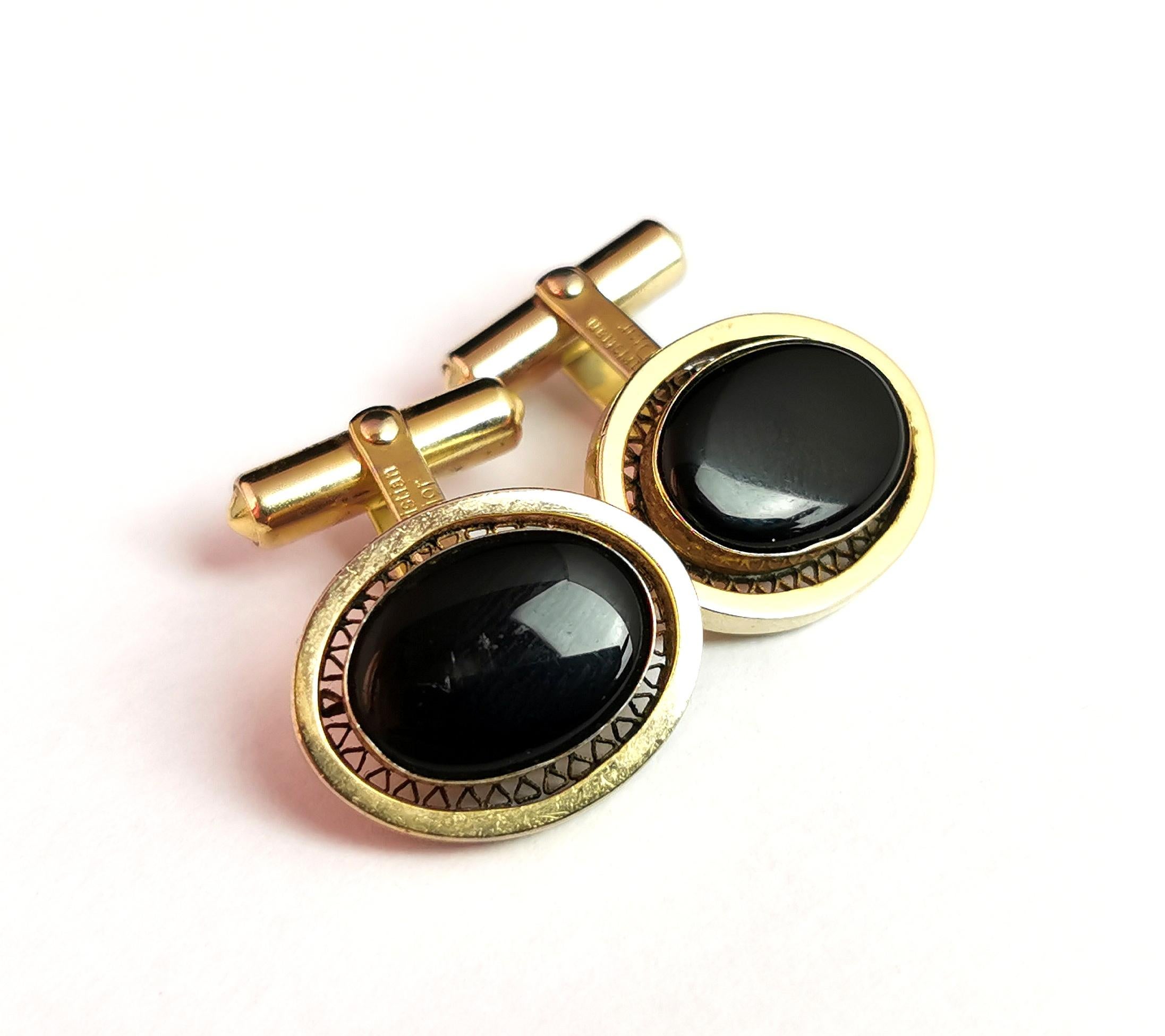 A handsome pair of vintage Christian Dior cufflinks.

Gold tone metal with a black enamelled oval centre and a cut out lattice metalwork rim.

The cufflinks are both marked for Christian Dior with a patent and branding.

Condition:
Good used