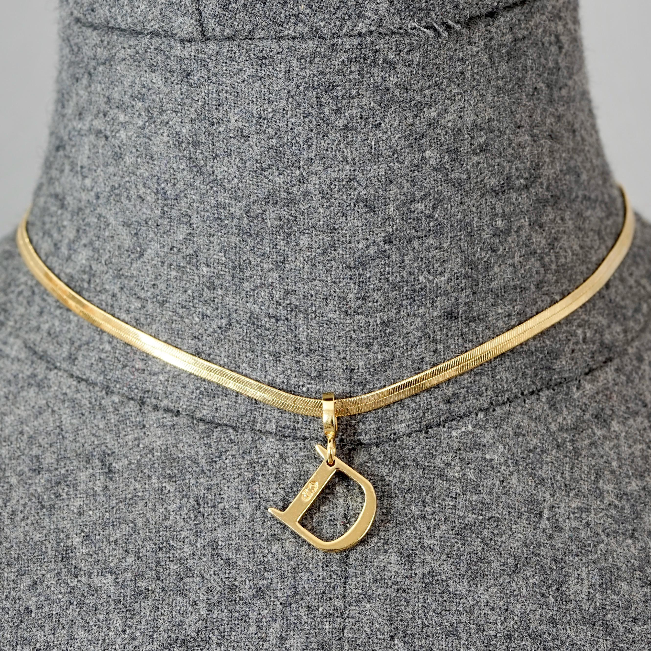 Vintage CHRISTIAN DIOR D Logo Pendant Snake Chain Necklace

Measurements:
Height: 1.02 inches (2.6 cm)
Wearable Length: 10.43 inches to 12.59 inches (26.5 cm to 32 cm)

Features:
- 100% Authentic CHRISTIAN DIOR.
- Snake chain necklace with D pendant
