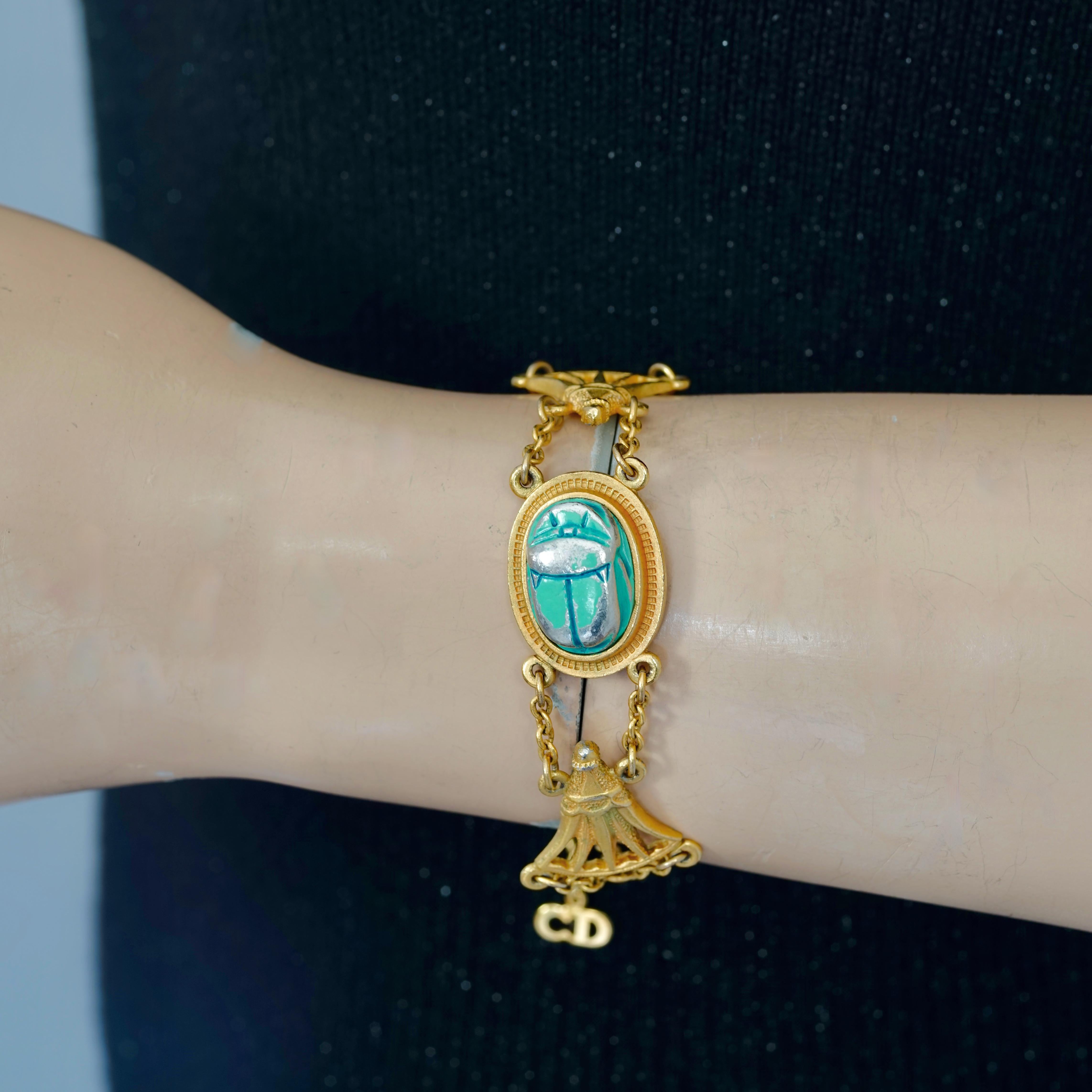 Vintage CHRISTIAN DIOR Egyptian Revival Scarab Chain Bracelet

Measurements:
Height: 0.78 inch (2 cm)
Adjustable Total Length: 8.07 inches (20.5 cm) maximum

Features:
- 100% Authentic CHRISTIAN DIOR.
- Egyptian Revival style bracelet with faux