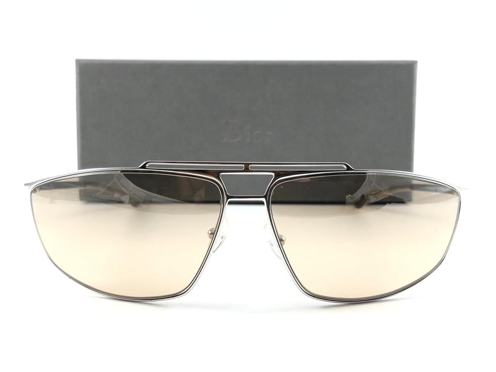 Vintage Christian Dior Diorminiglam silver with light mirrored light brown lenses Wrap Sunglasses Fall 2000 by Galliano.

Made in Austria.
 
This piece show minor sign of wear due to  storage.

Front : 16.5 cms

Lens Height : 3.5 cms

Lens Width : 6