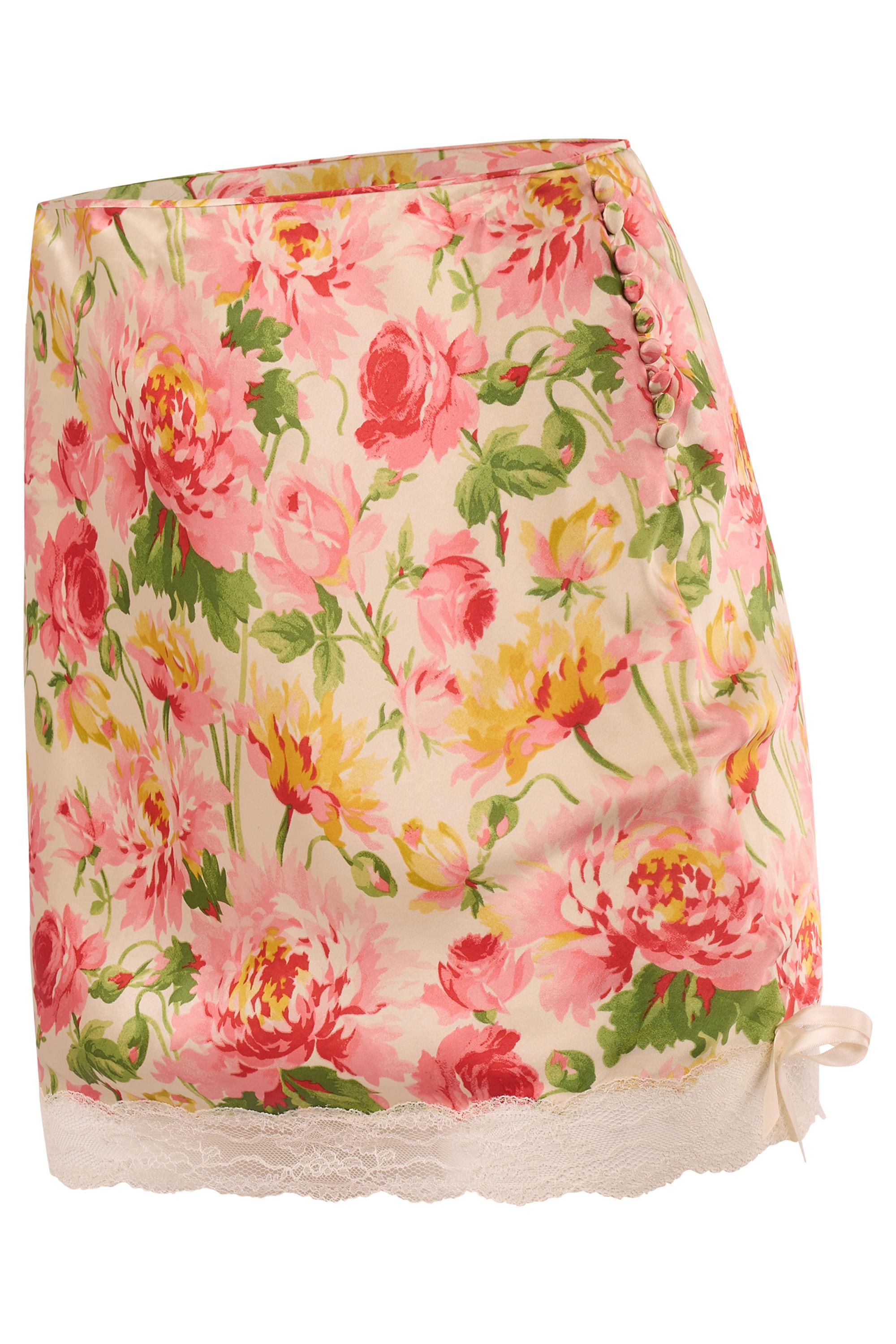 Vintage Christian Dior Fall/Winter 2003/04 floral lace mini skirt. Crafted from delicate silk with a painterly floral print in pink, yellow, and green hues, the piece features a scalloped lace hem that peeks beneath the skirt and satin ribbon bows