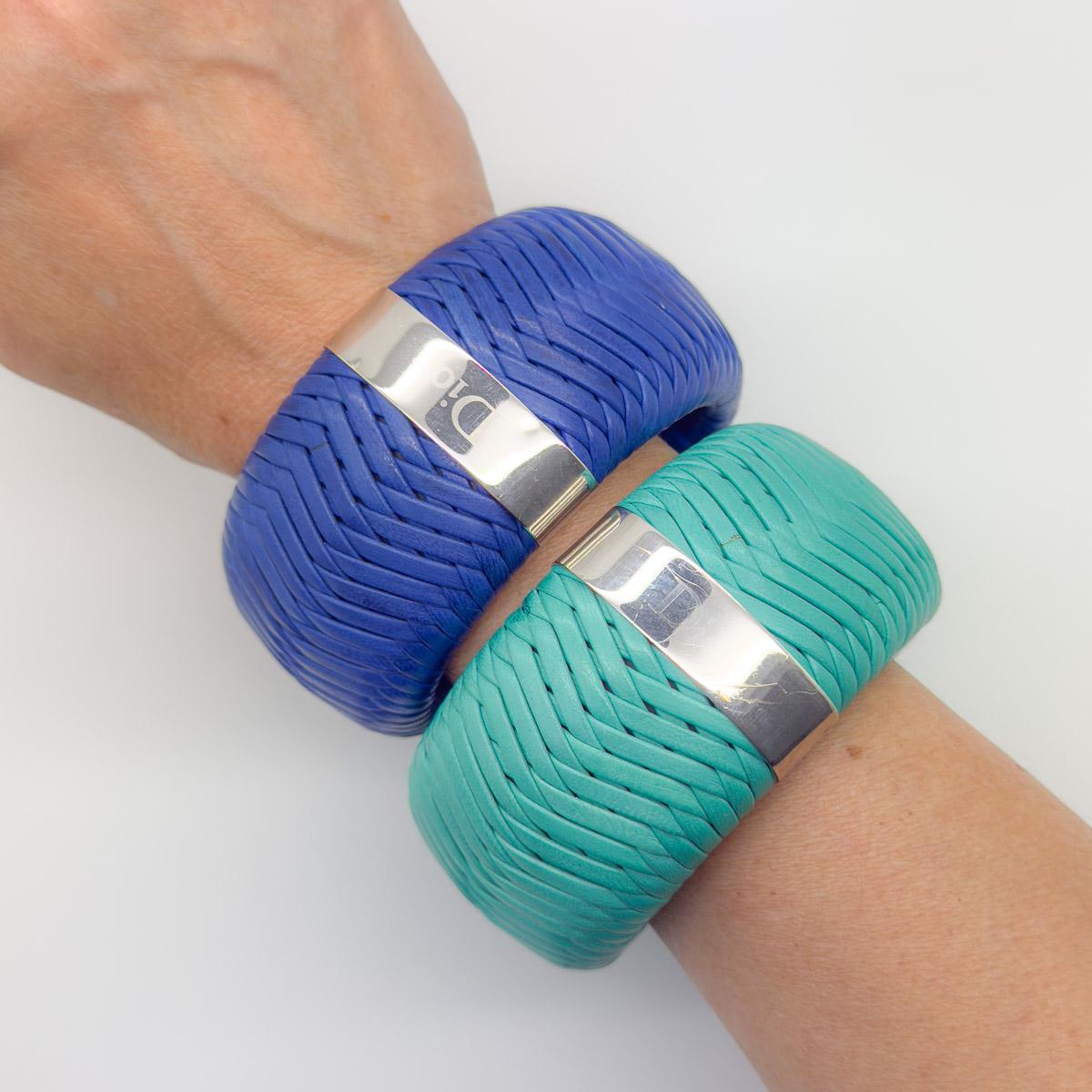 A gigantic pair of Dior Bangles, stacking to create the ultimate Dior statement. The duo comprising a vibrant green and a deep blue woven leather bangle. Striking in scale and finished with a DIOR chromed band (the logo now faded on the green). A
