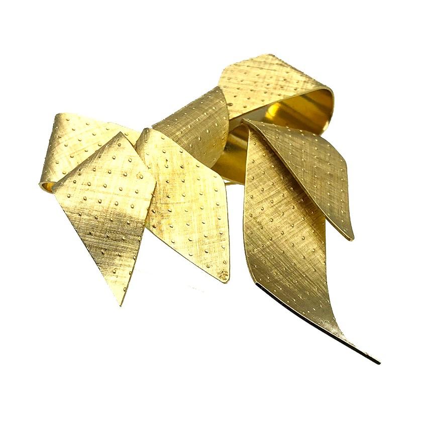 A standout gigantic Vintage Dior Bow Brooch of huge proportions. Crafted in gold plated metal with textured finishing and stud detail. This cleverly designed piece by the house artfully depicts a stylised version of a classic large floppy bow in