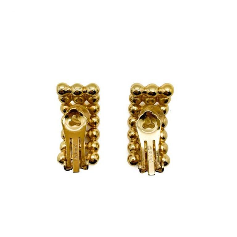 Emulating lines of small golden beads styled in a half hoop, these vintage Dior bobble earrings offer a classic style with outstanding quality. Created by the House of Dior in the 1990s these Dior bead earrings are finely styled and plated in a very