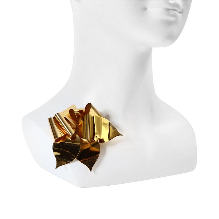 Vintage Christian Dior Gold Brooch Circa 1980s. The Brooch is in an origami like pattern of a bow.  Like it is a fabric bow and has been made into metal. This will look great anywhere. Would also be spectacular on a black silk cord which I will