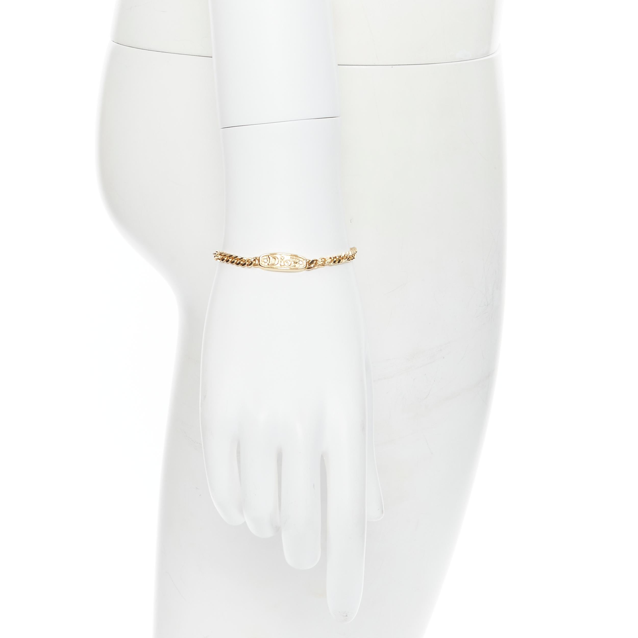 vintage CHRISTIAN DIOR gold crystal logo ID tag bracelet 
Reference: TGAS/B00712 
Brand: Christian Dior 
Designer: John Galliano 
Material: Metal 
Color: Gold 
Pattern: Solid 
Closure: Clasp 

CONDITION: 
Condition: Very good, this item was