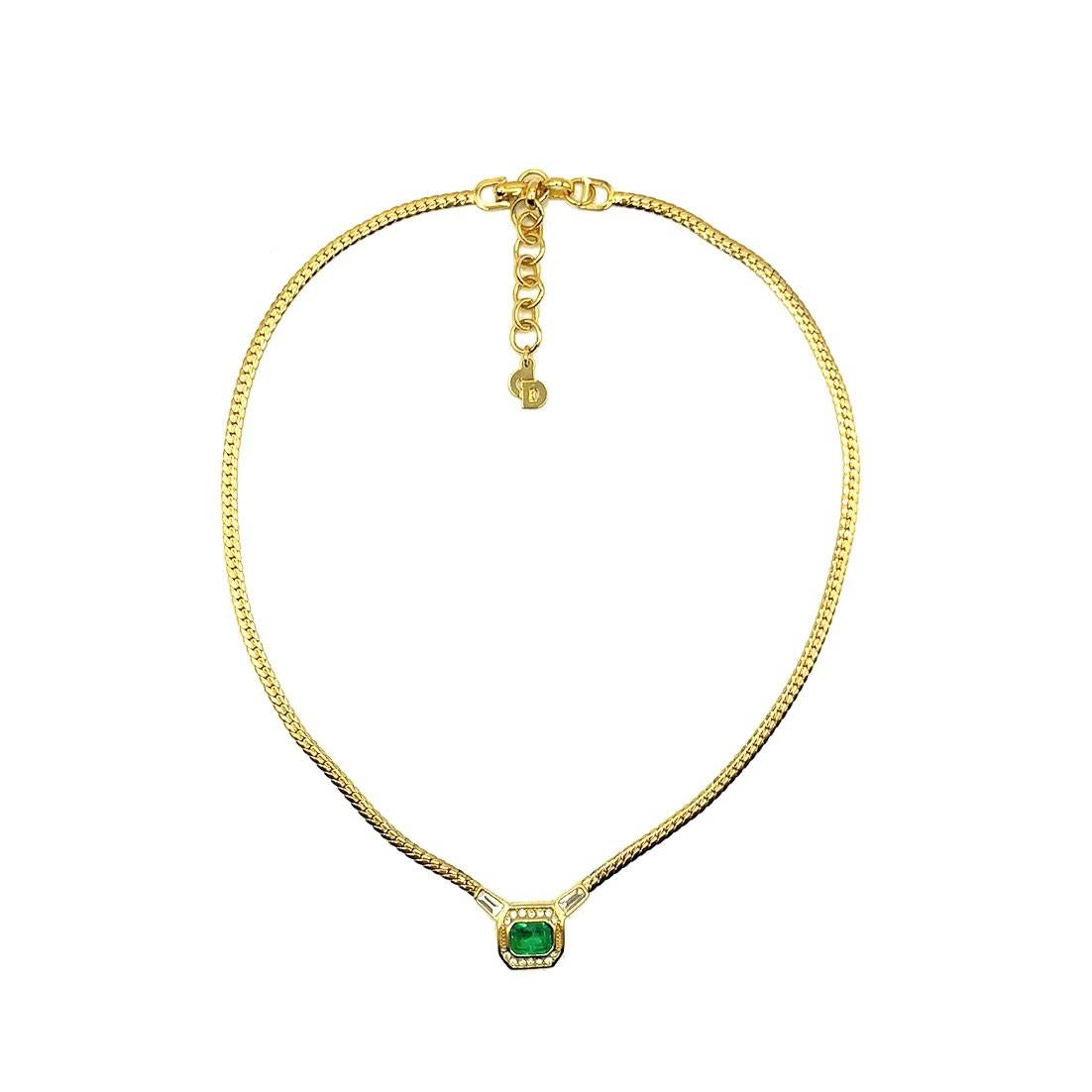 A beautiful Vintage Dior Emerald Necklace. Crafted in gold plated metal and set with a lovely emerald coloured crystal surrounded by clear crystal chaton and tapered baguette stones. In very good vintage condition. Signed. 39-44cms adjustable.