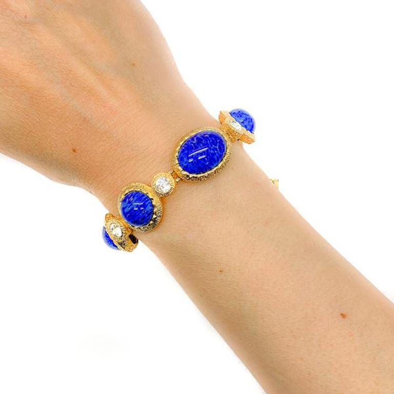 A fabulous Vintage Dior Lapis Bracelet. Featuring stippled gold plated metal and wonderful deep rich blue cabochon lapis lazuli glass stones, accented with sparkling clear glass crystals. 18.5cm, signed and in very good vintage condition. Stunning
